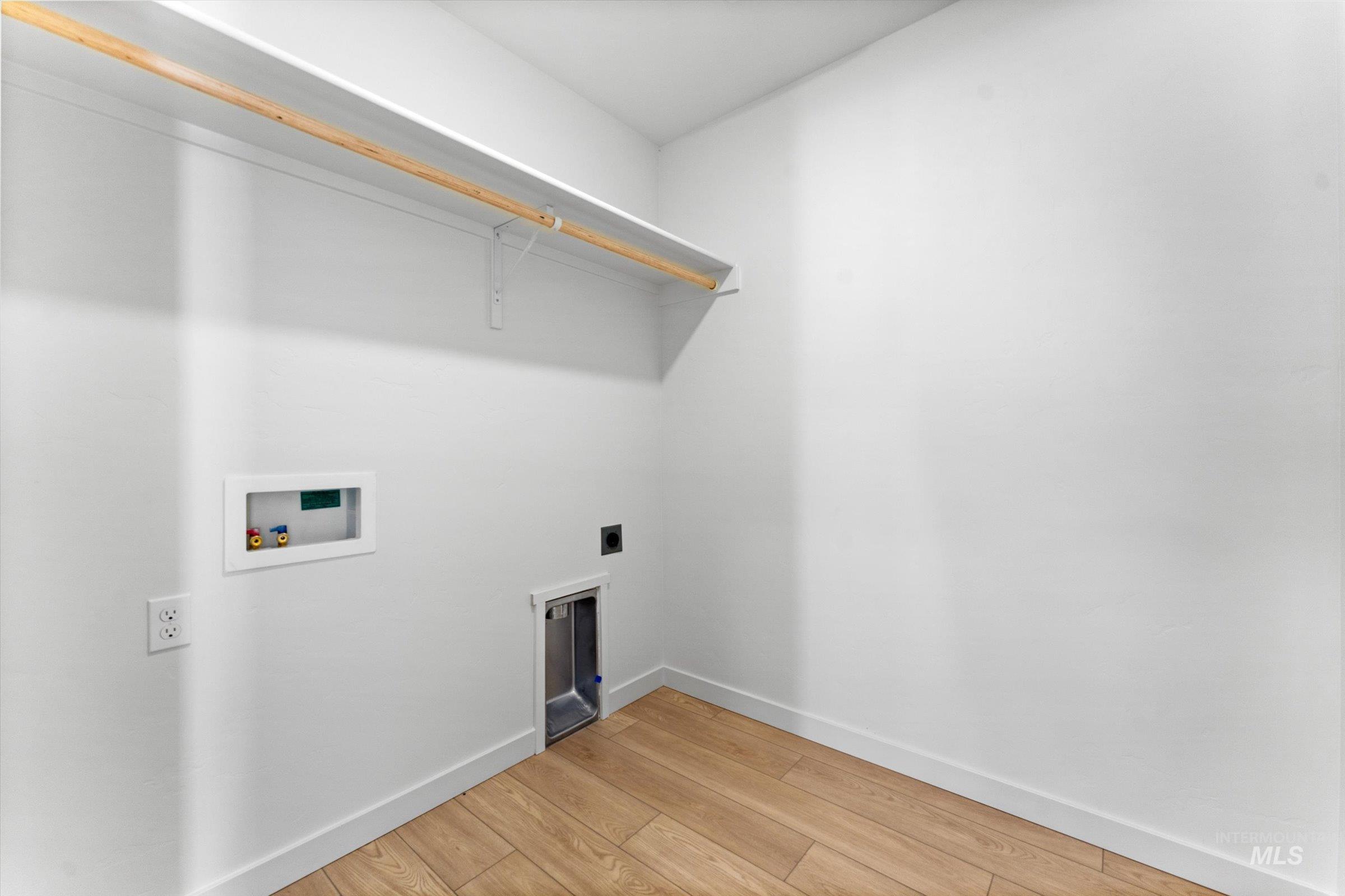 Laundry room featuring electric dryer hookup, light wood-style flooring, and hookup for a washing machine