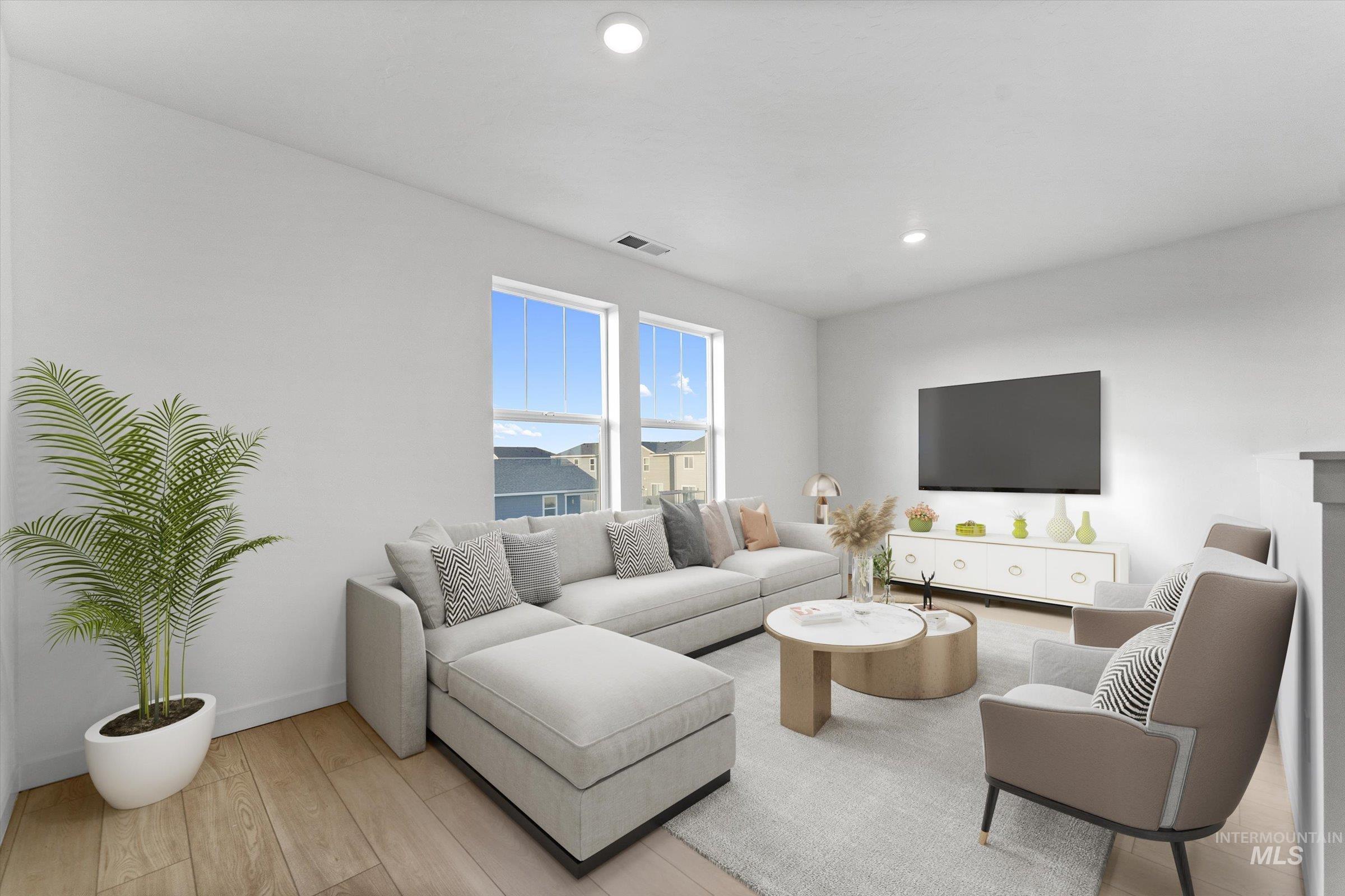 Living room featuring light wood-style flooring and recessed lighting