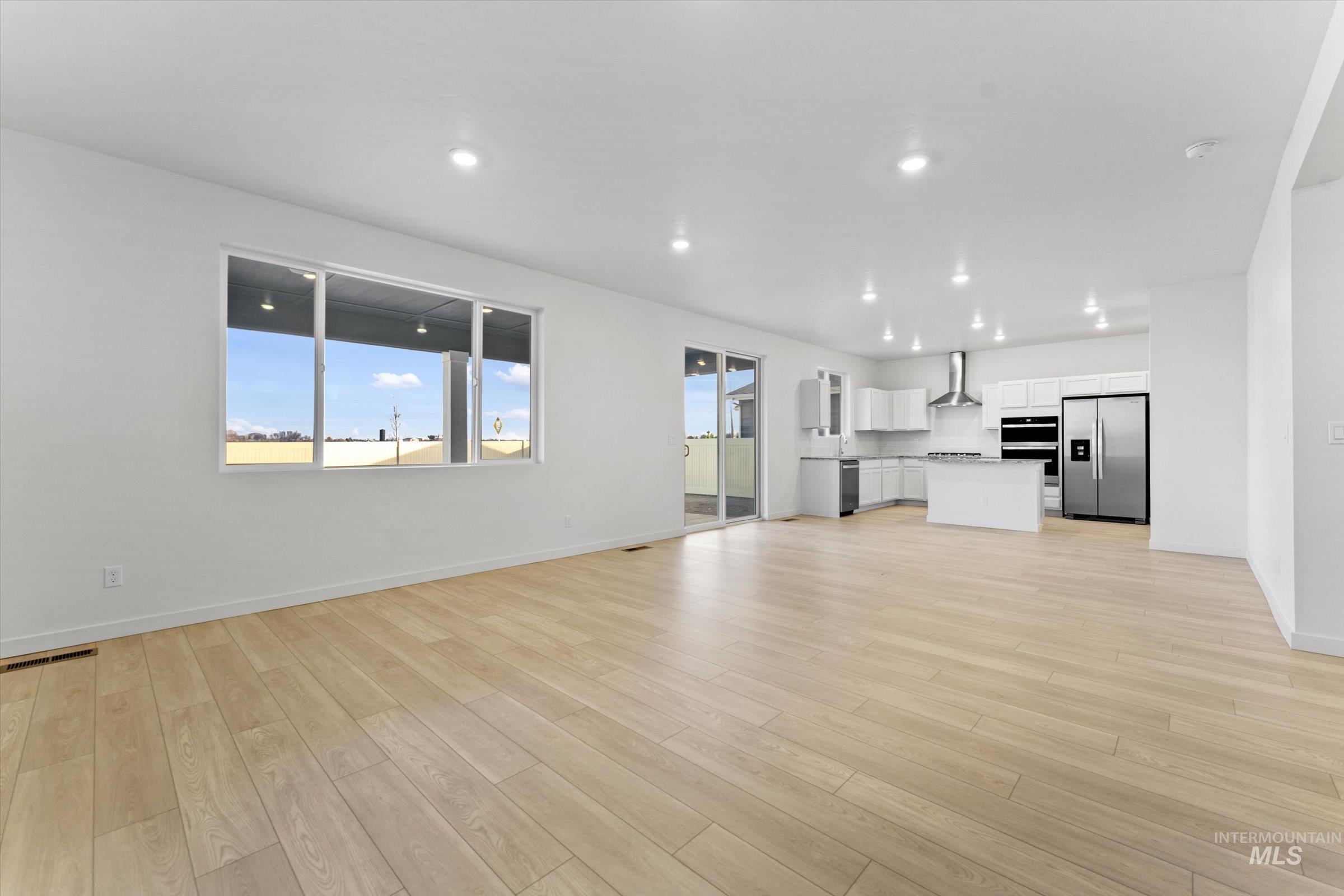 Unfurnished living room featuring light wood-style floors and recessed lighting