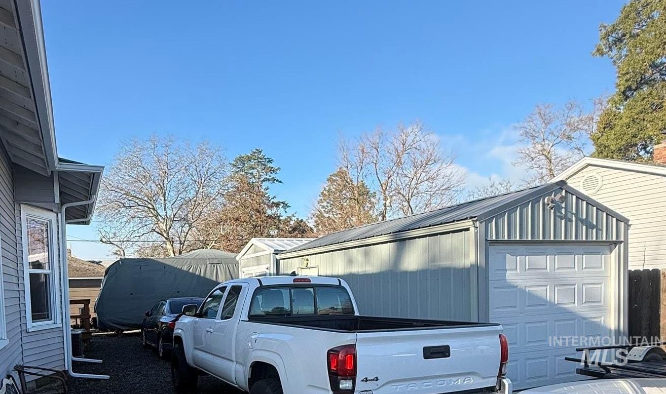 View of side of home with a garage and an outdoor structure