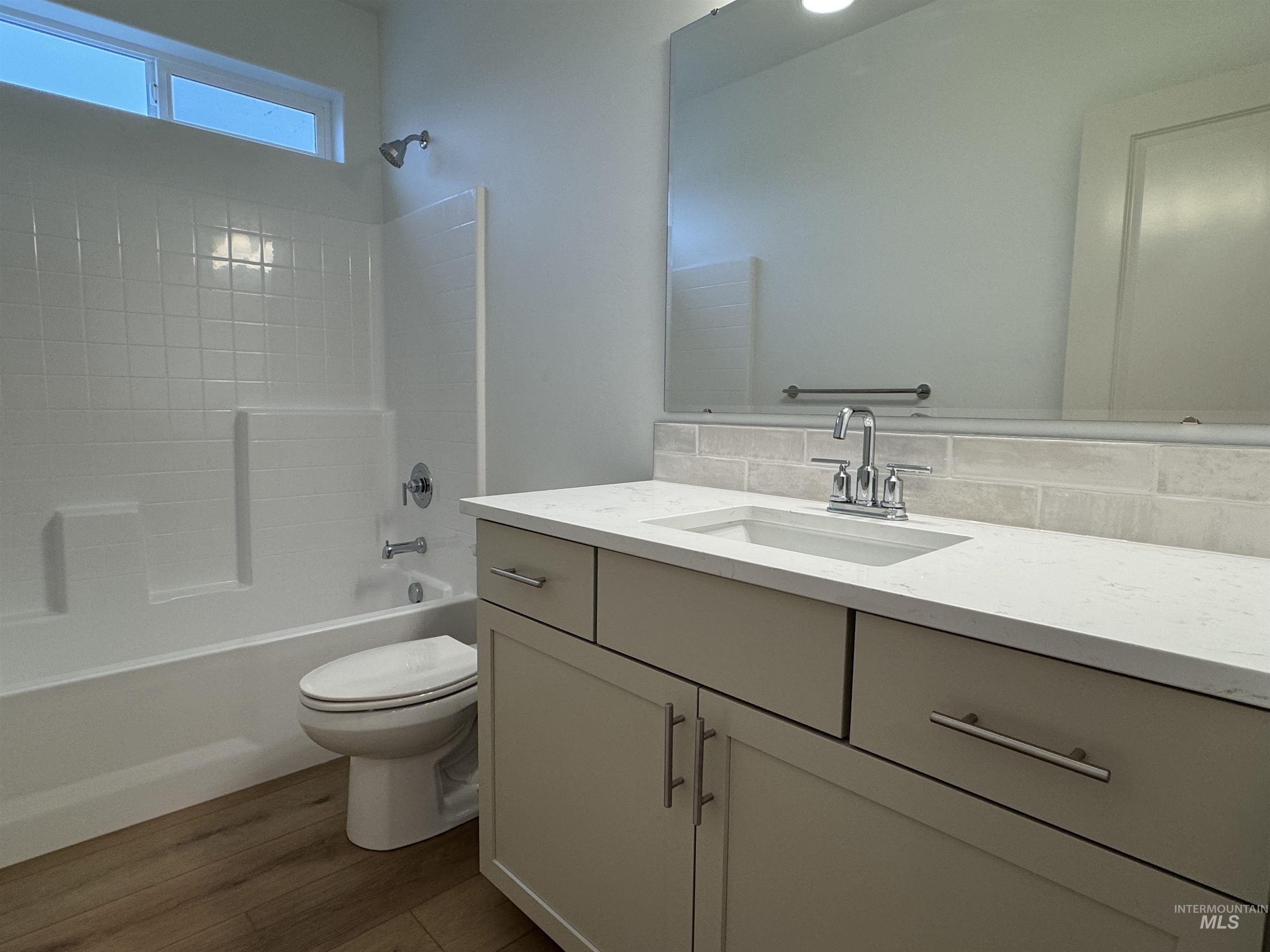 Full bathroom featuring vanity, shower / washtub combination, and dark wood-type flooring