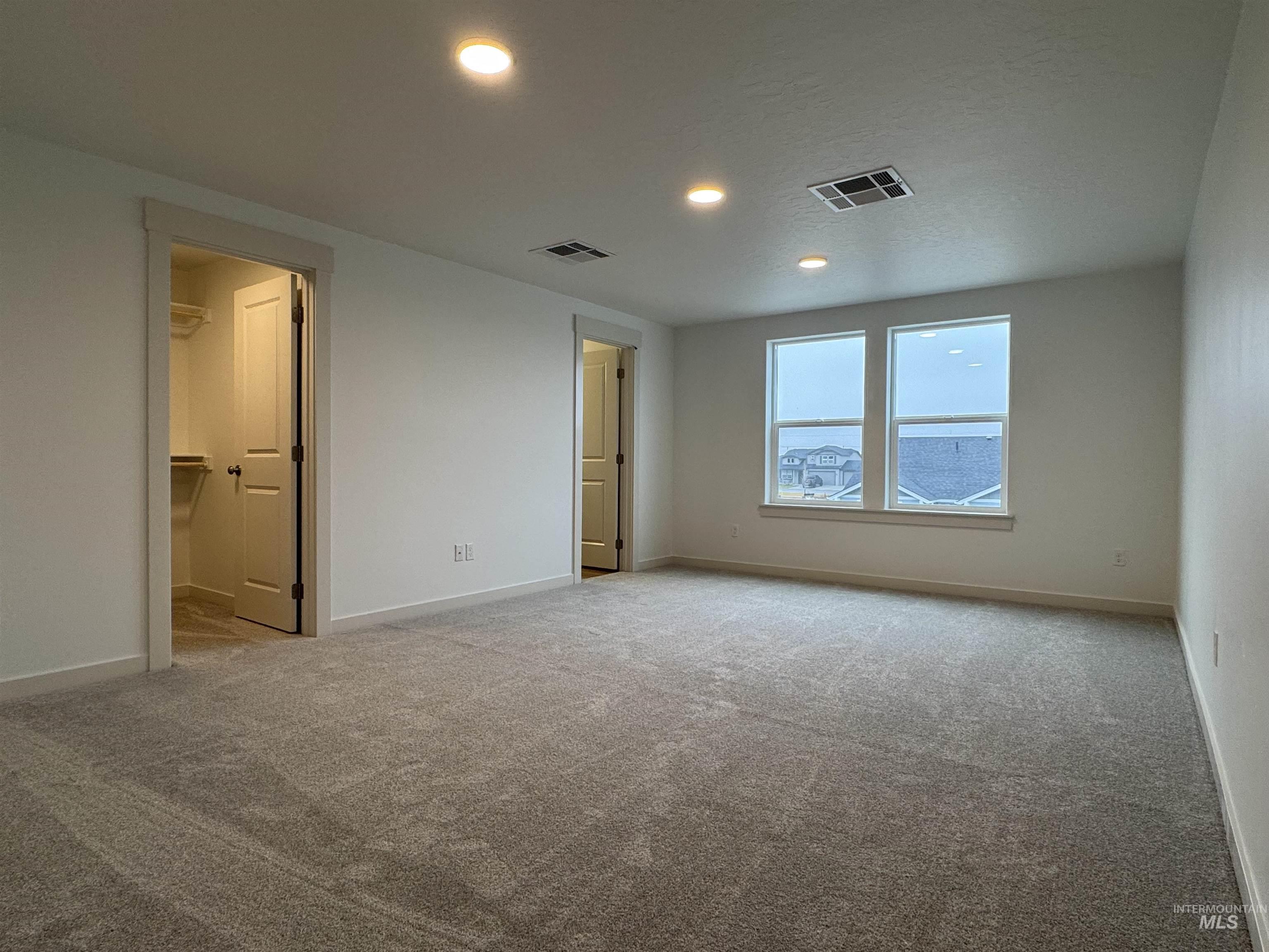 Unfurnished bedroom featuring recessed lighting and light colored carpet