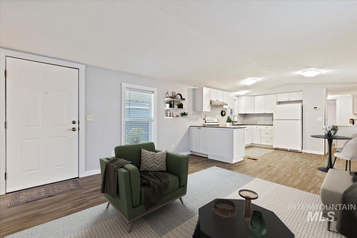Living room featuring lofted ceiling and light wood finished floors