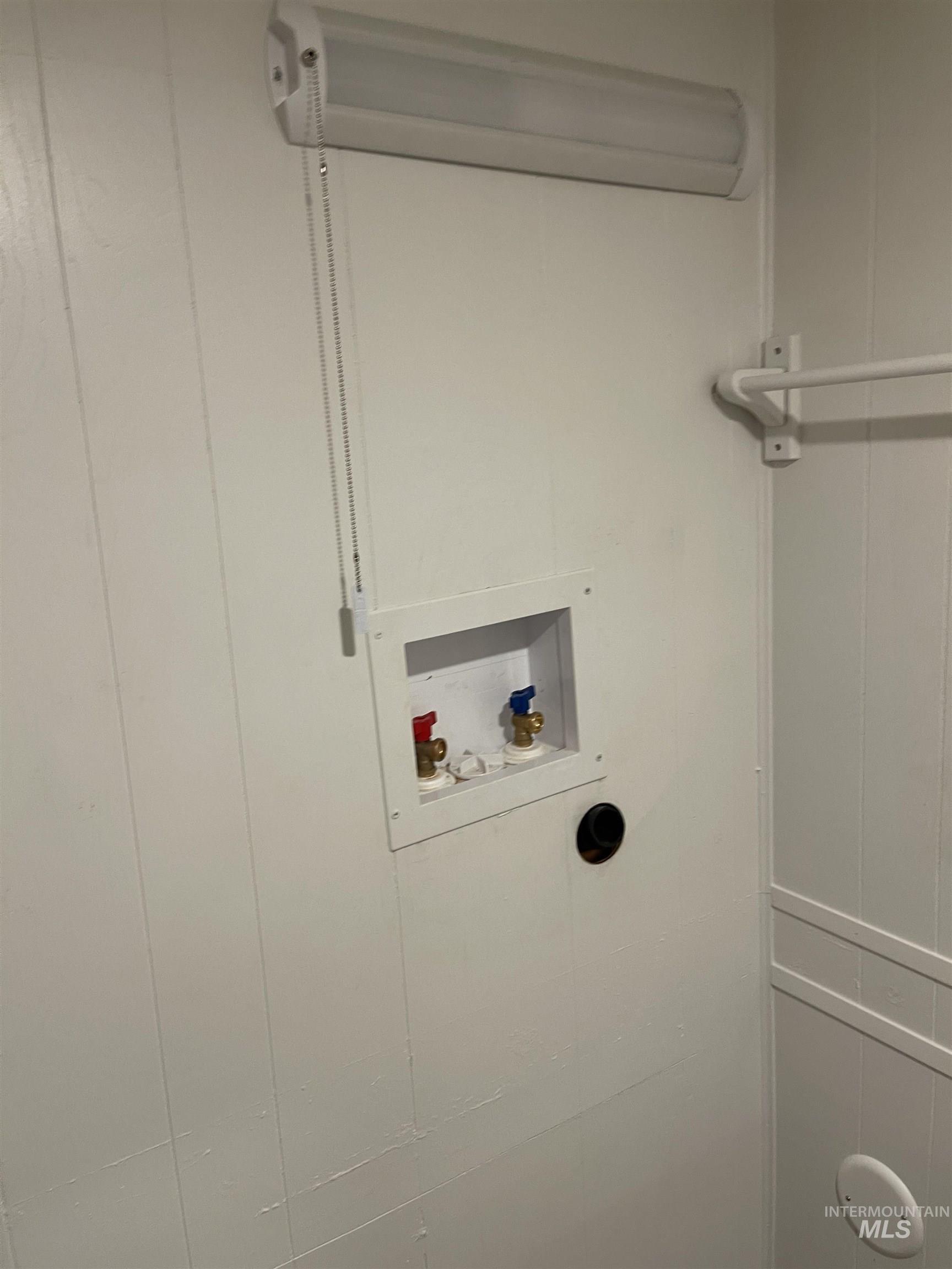 Laundry room with washer hookup and a wall mounted AC