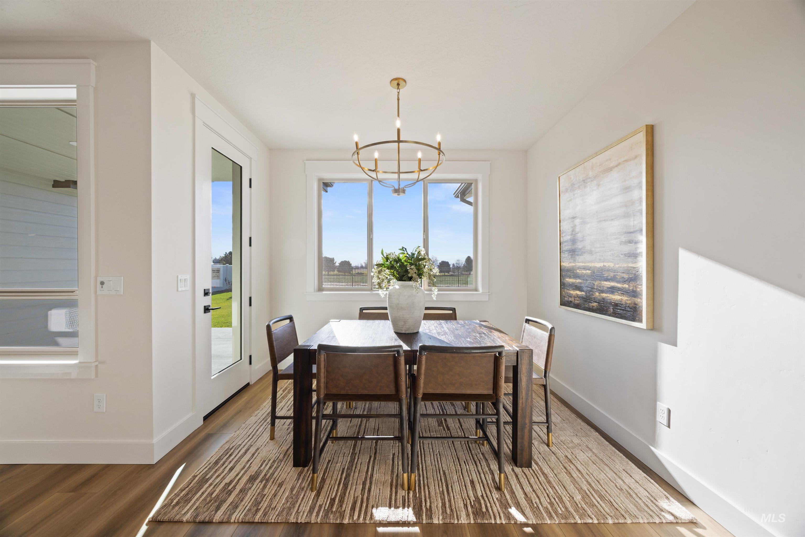 Dining area featuring wood finished floors and a chandelier