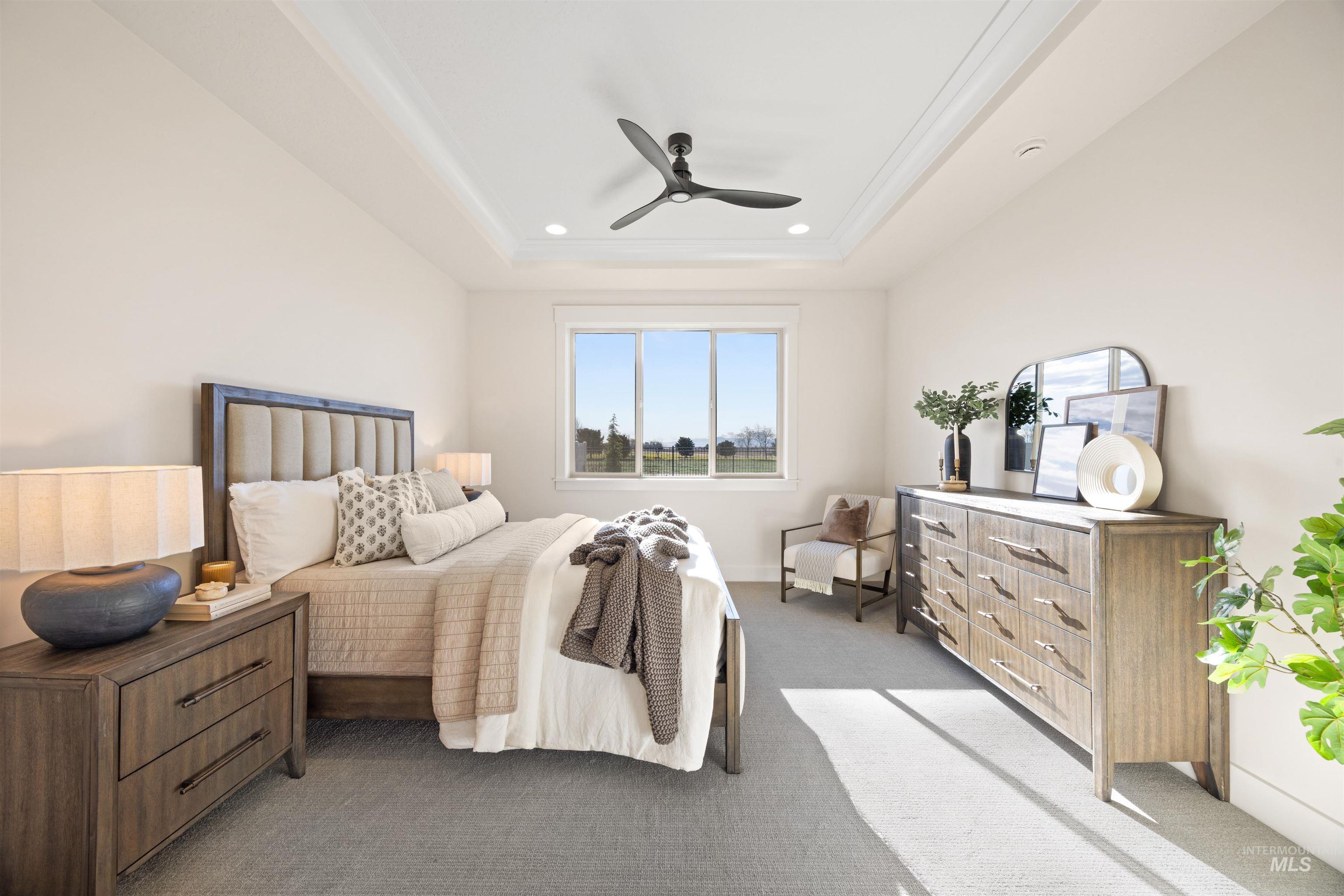 Carpeted bedroom featuring ceiling fan, a tray ceiling, and recessed lighting