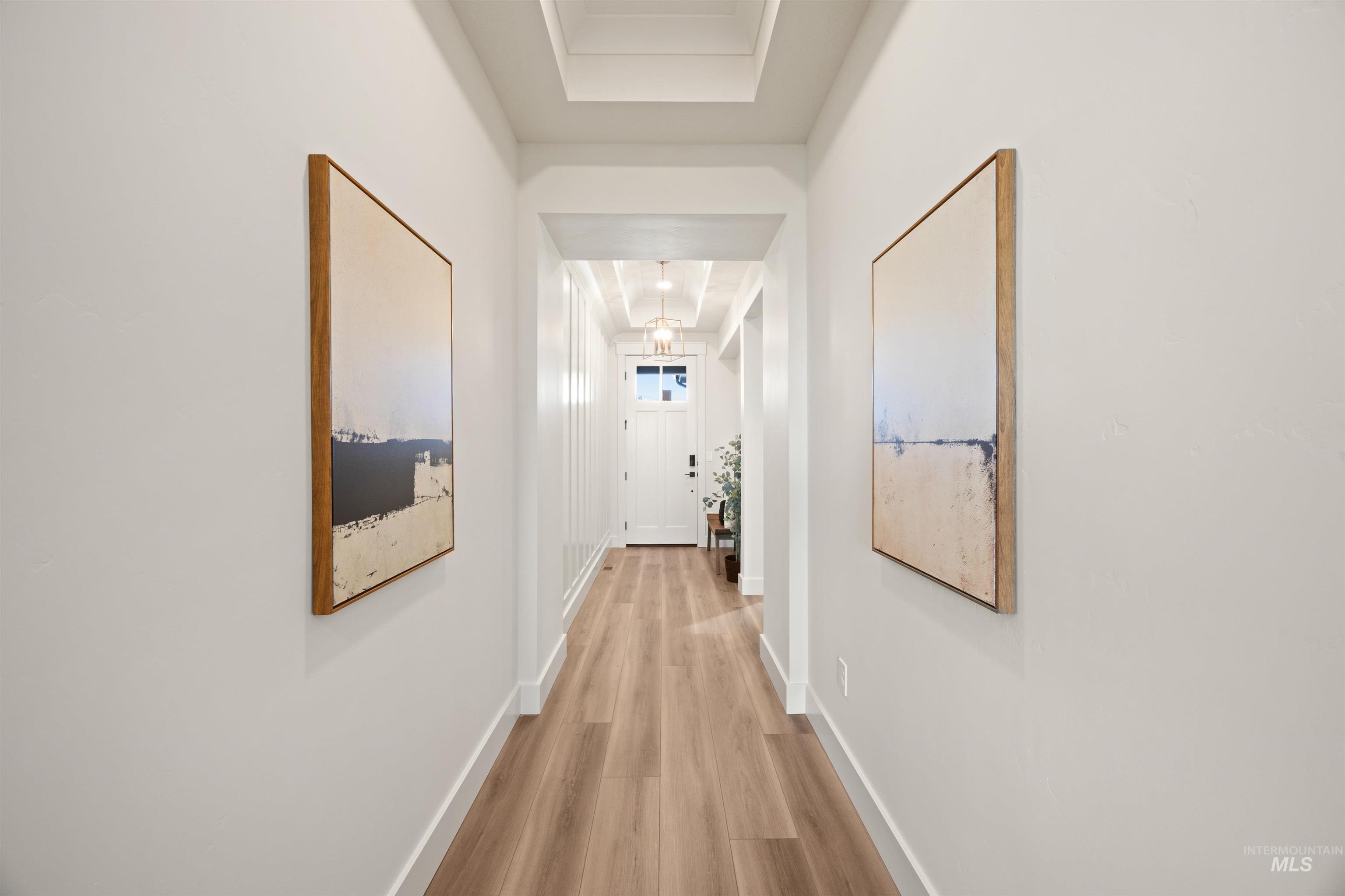 Corridor featuring baseboards and wood finished floors