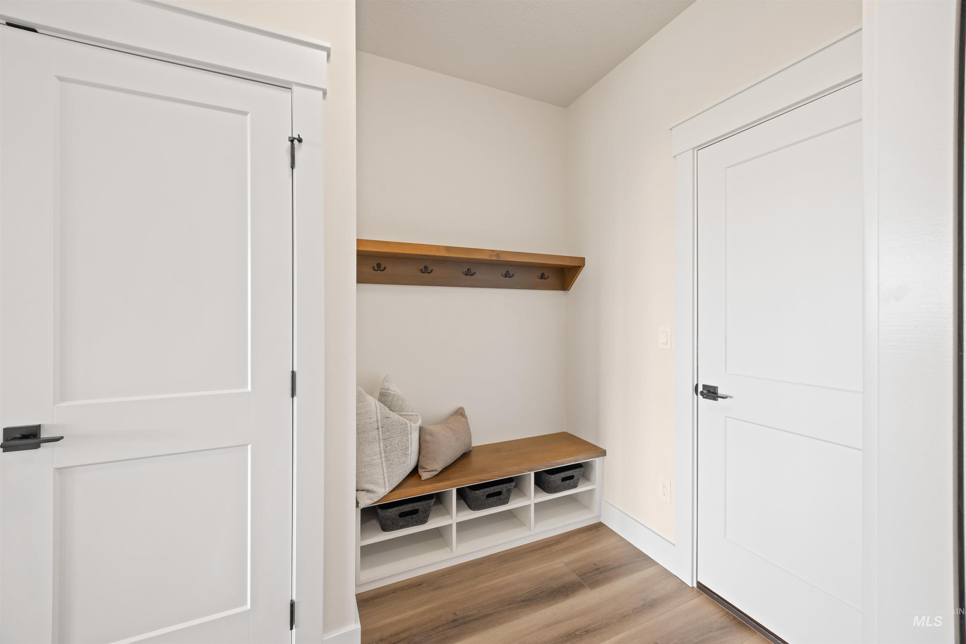 Mudroom with light wood-type flooring and baseboards