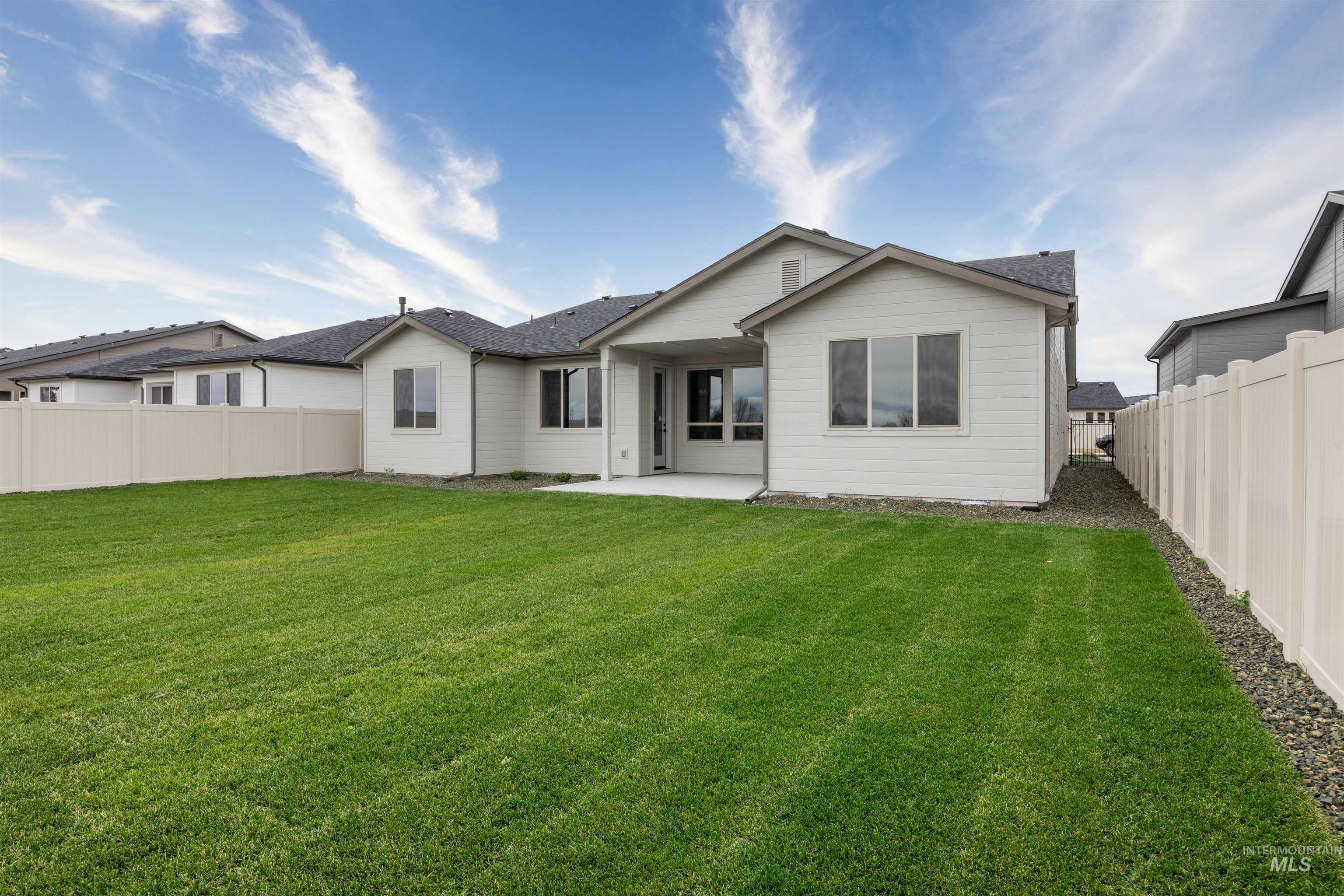 Rear view of house featuring a patio and a fenced backyard