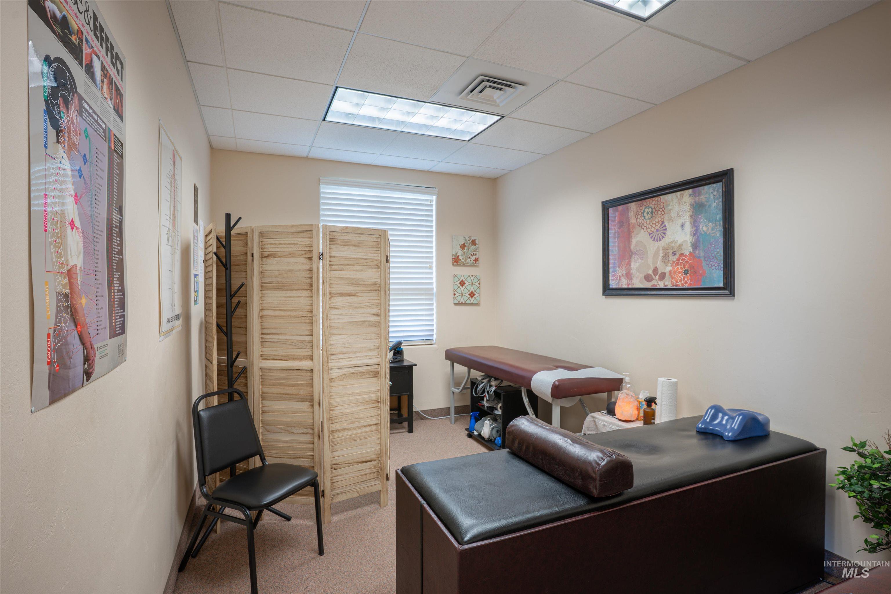 Office with a paneled ceiling