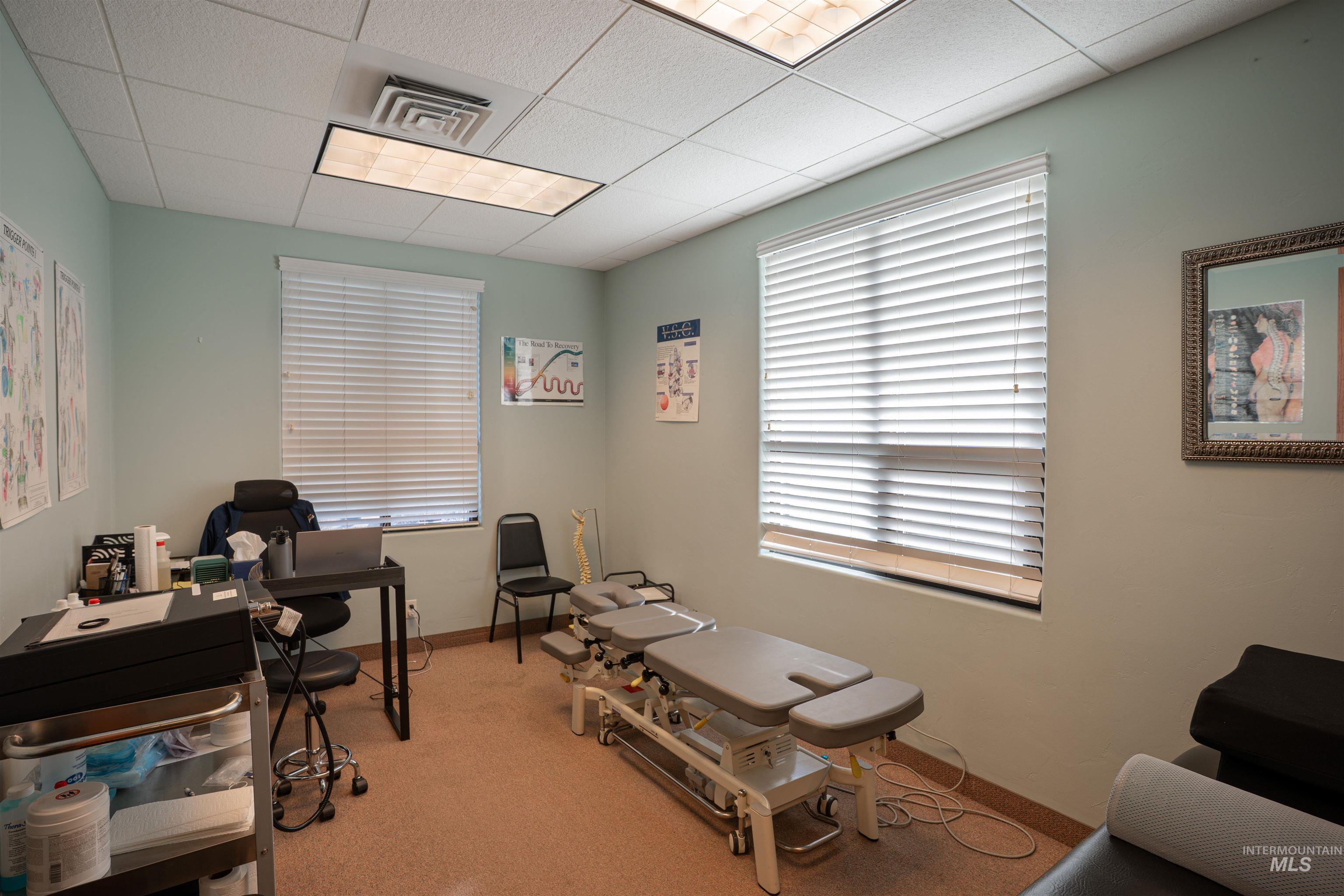 Office area with a paneled ceiling