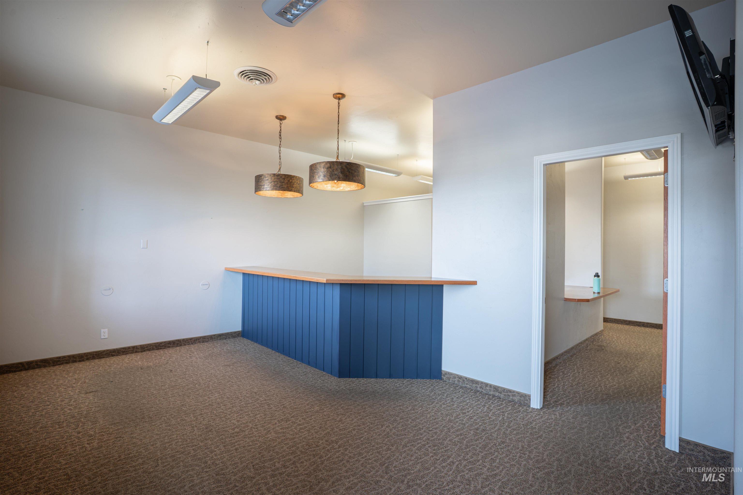 Bar featuring hanging light fixtures