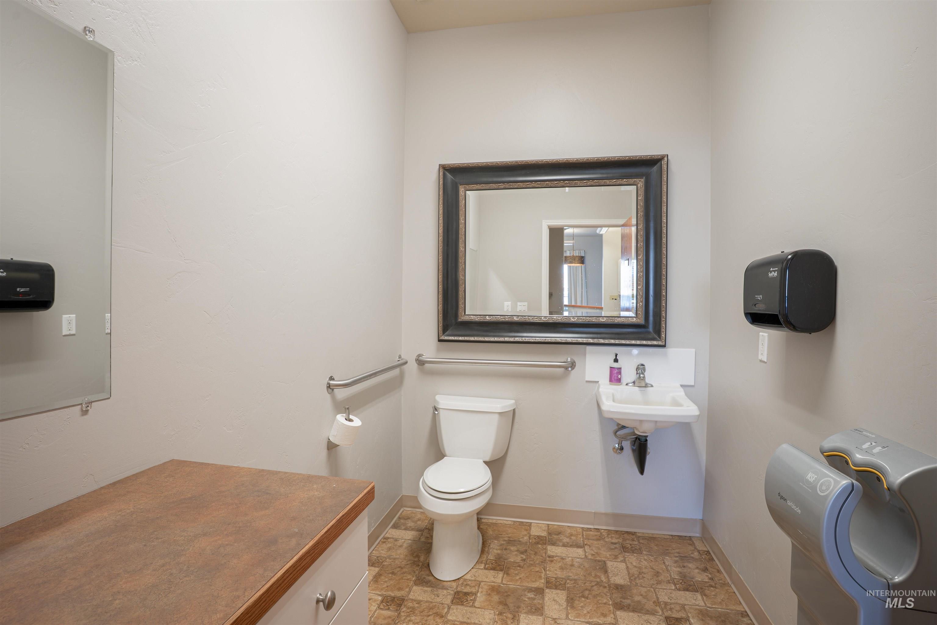 Bathroom with stone finish floors and toilet