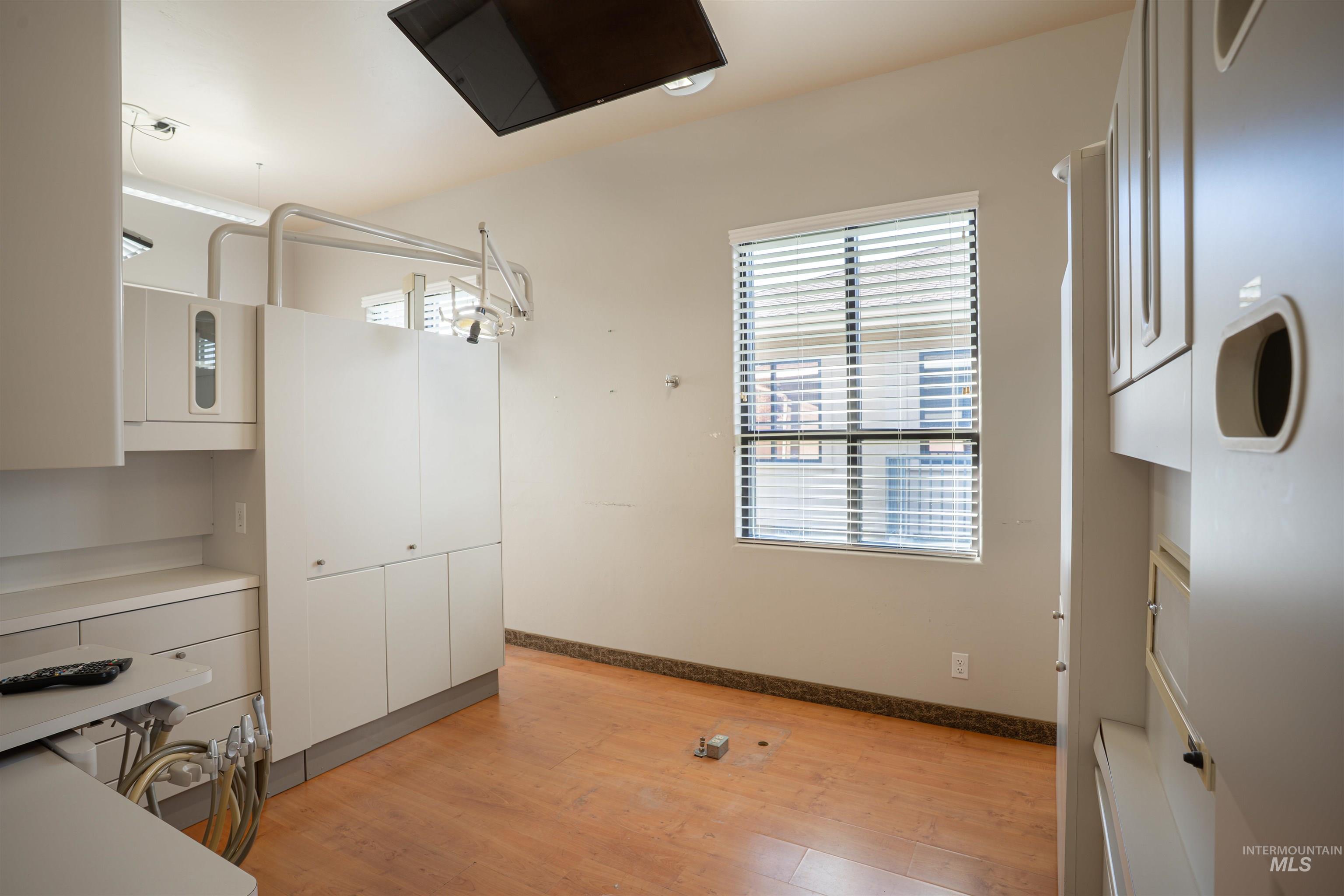 Unfurnished dining area with light wood finished floors and baseboards