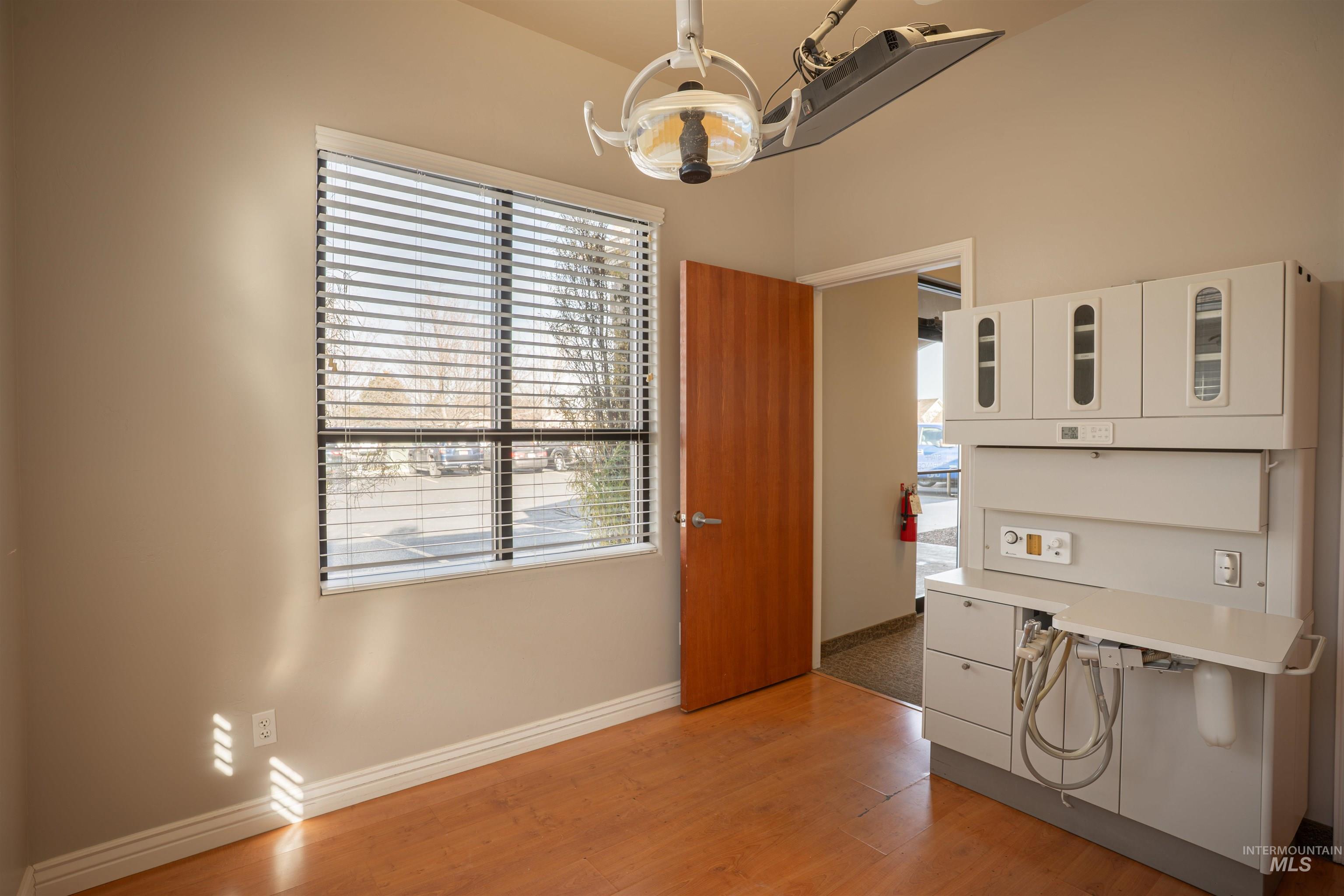 Dining area with light wood-style flooring and a chandelier