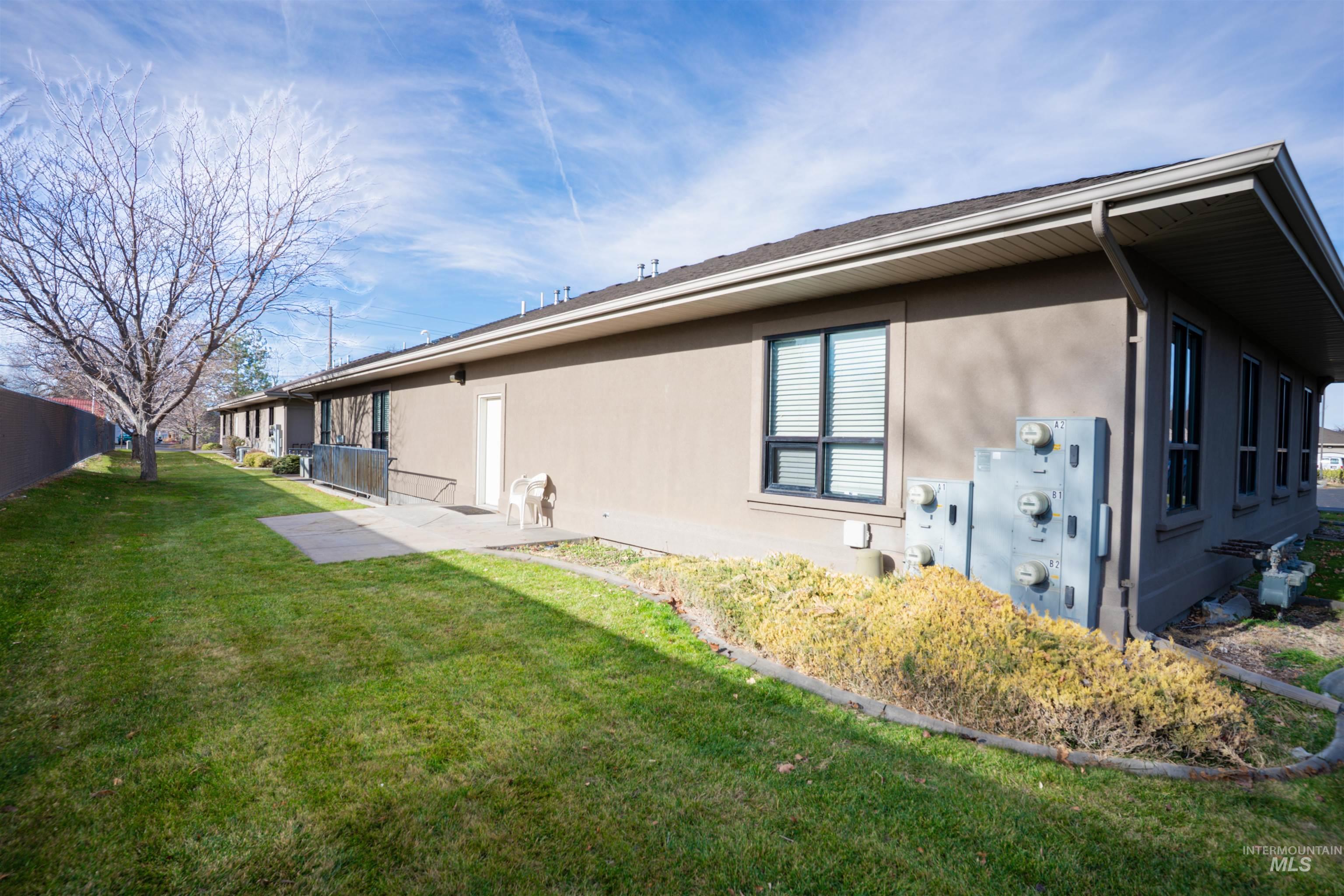 View of home's exterior with stucco siding and a yard