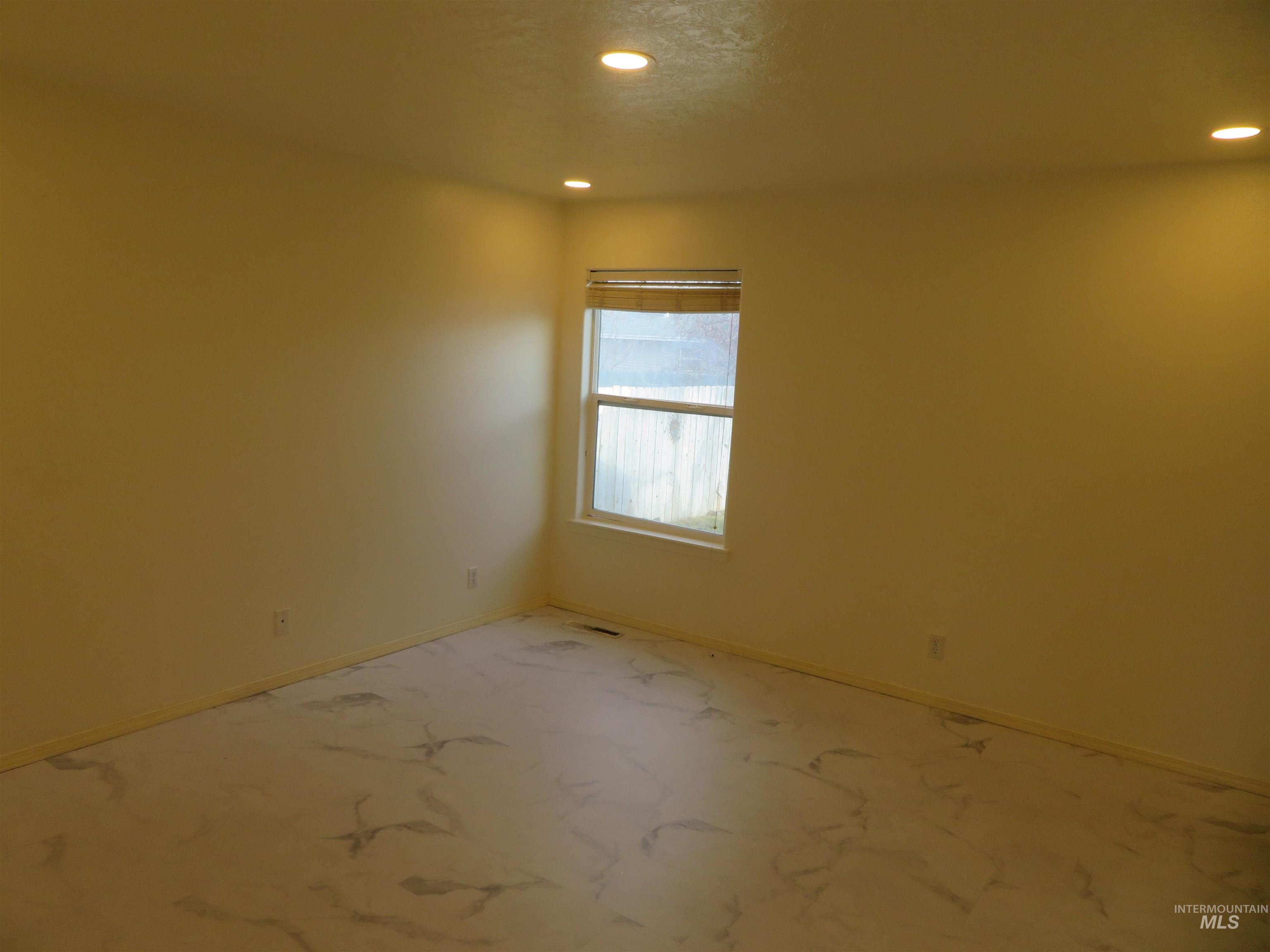 Unfurnished room featuring recessed lighting and baseboards