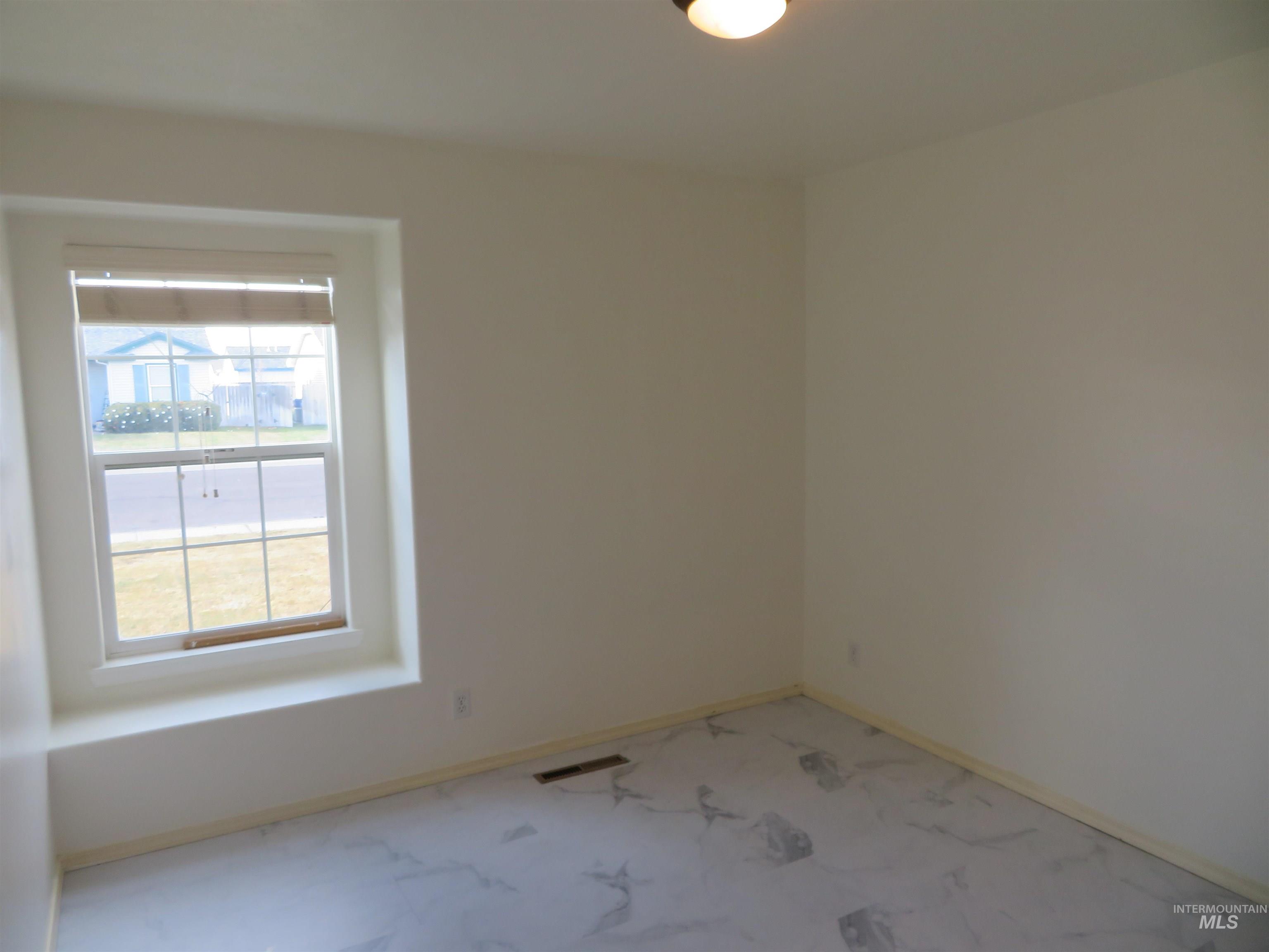 Empty room featuring baseboards