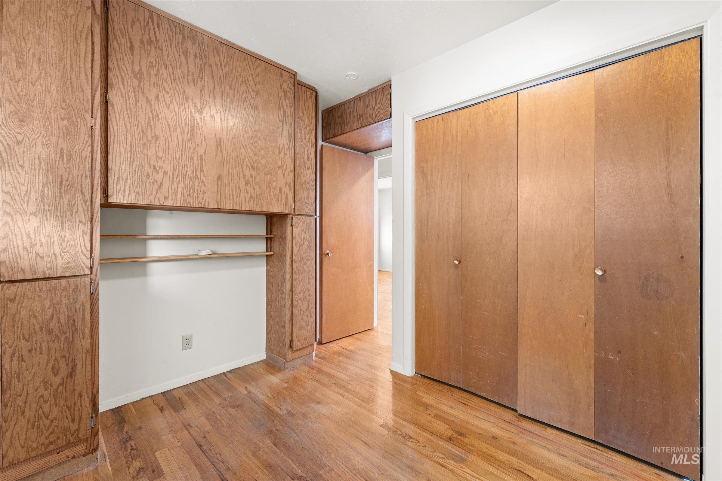 Unfurnished bedroom featuring light wood-style flooring and a closet