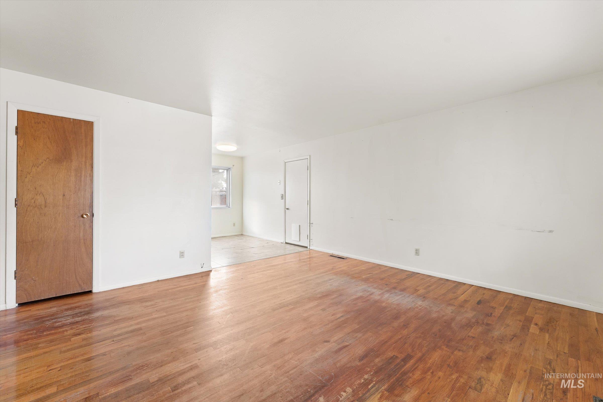 Empty room featuring wood finished floors