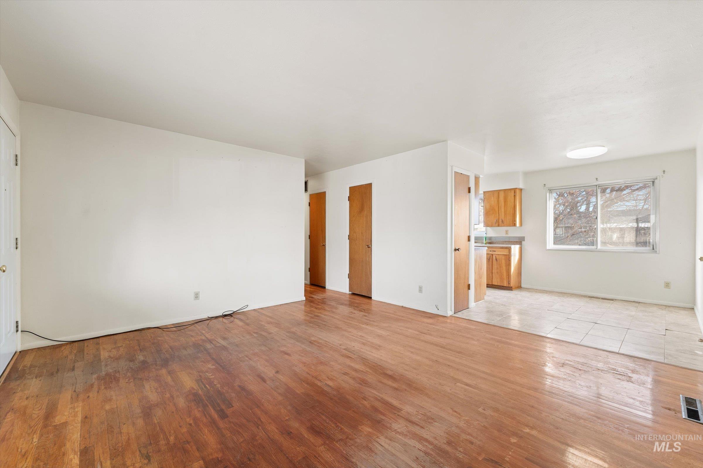Unfurnished living room with light wood-type flooring