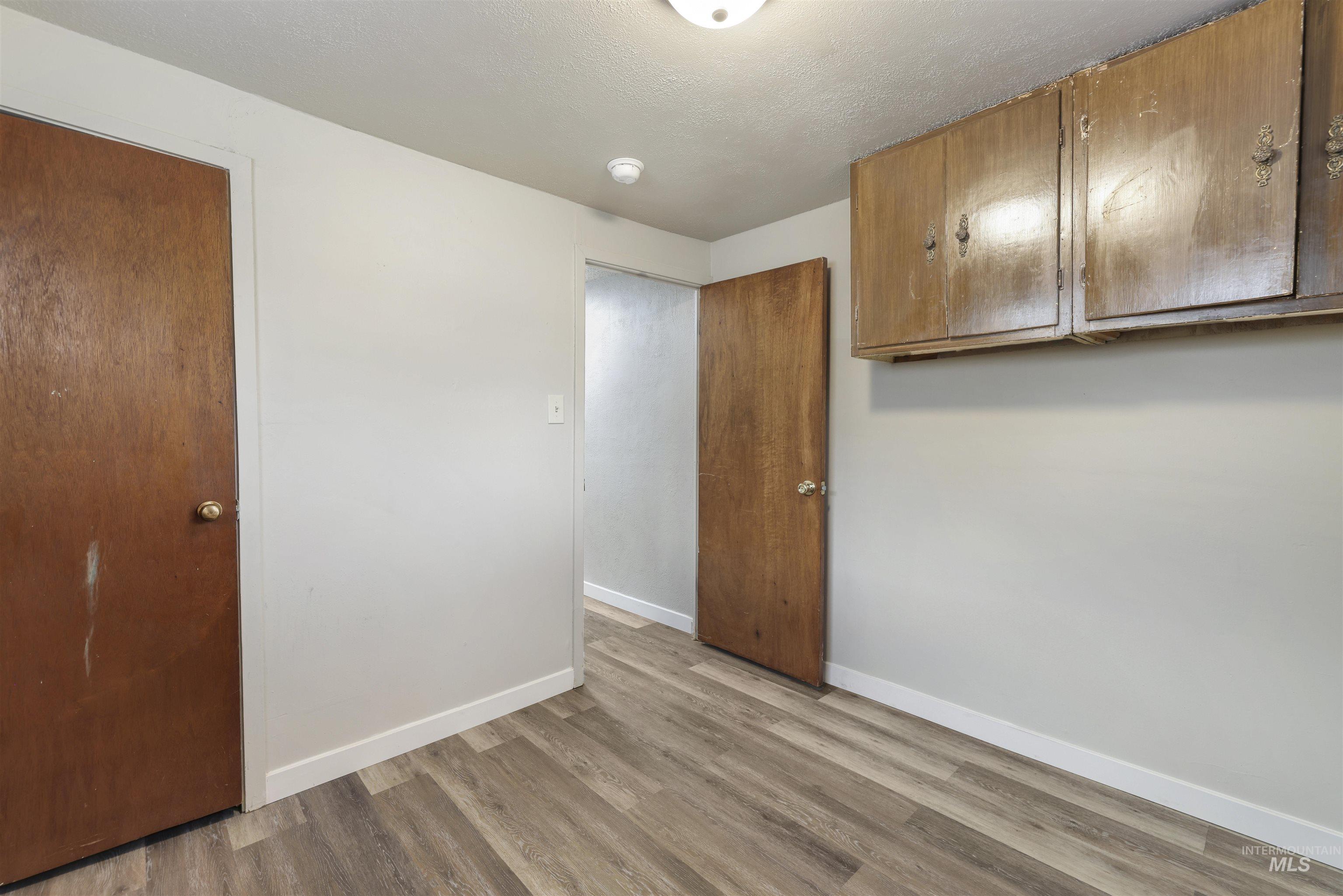 Unfurnished bedroom featuring a textured ceiling and light wood-type flooring