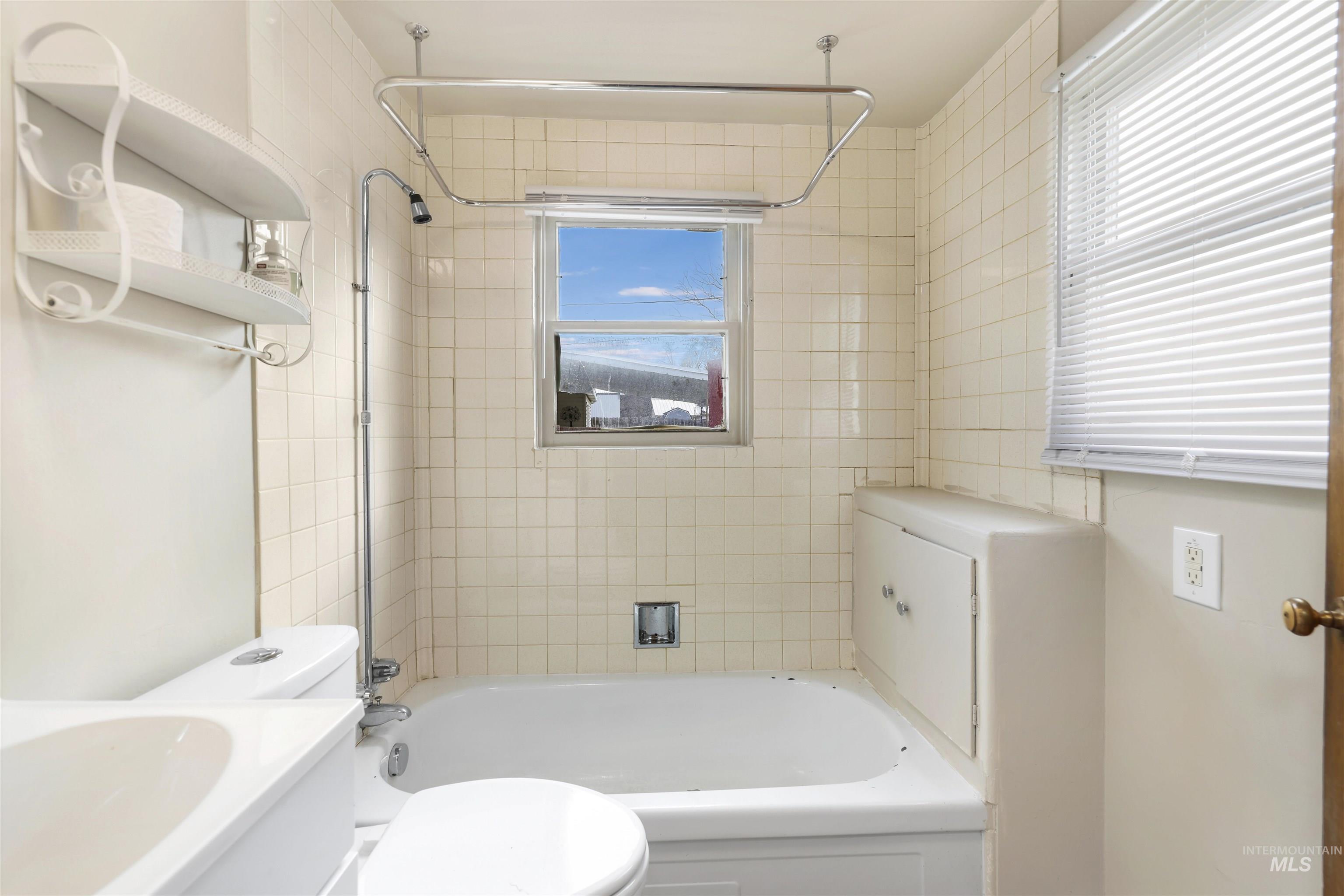 Bathroom with shower / bathtub combination and vanity