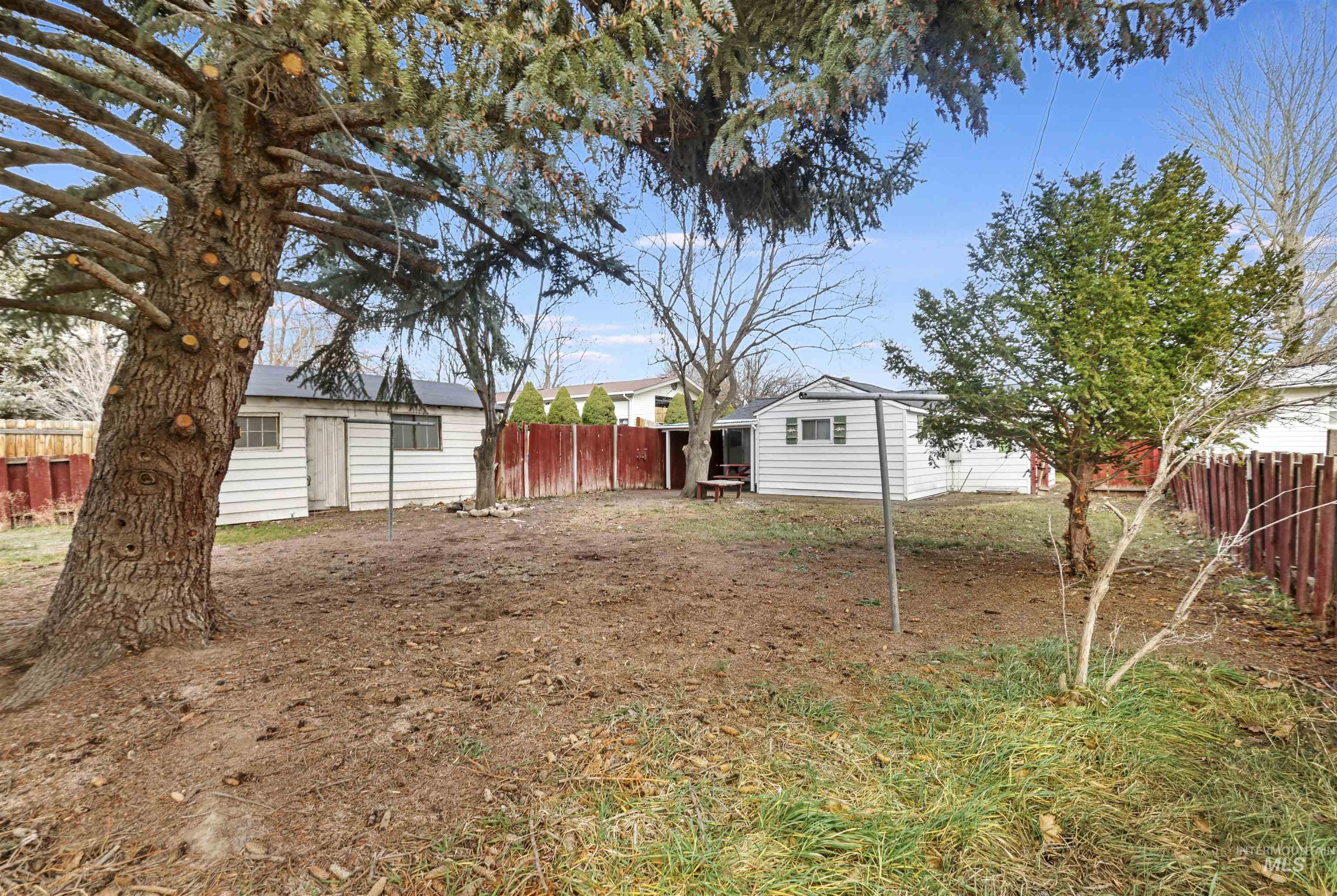 Fenced backyard with an outdoor structure