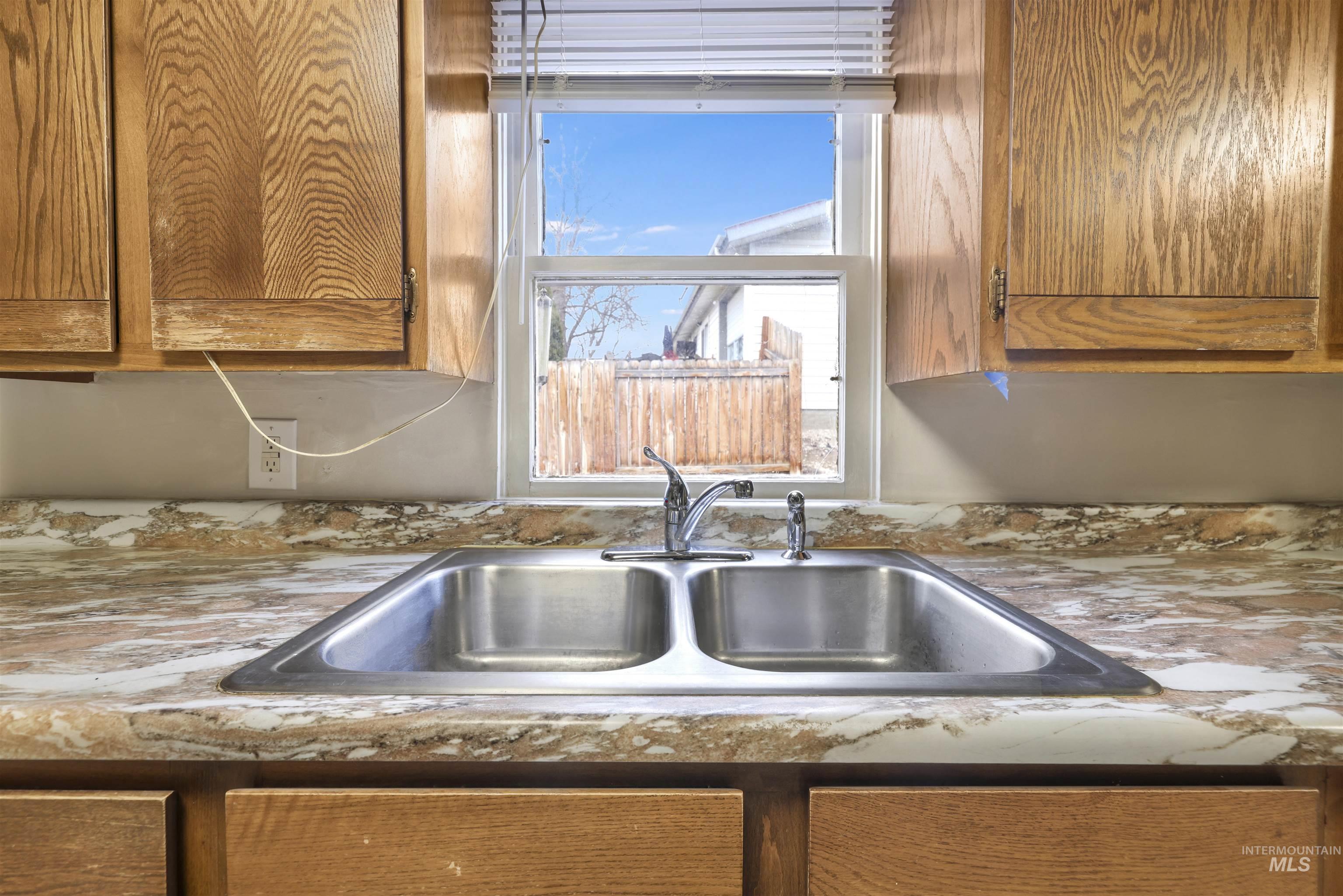 Kitchen view of brown cabinets and light countertops