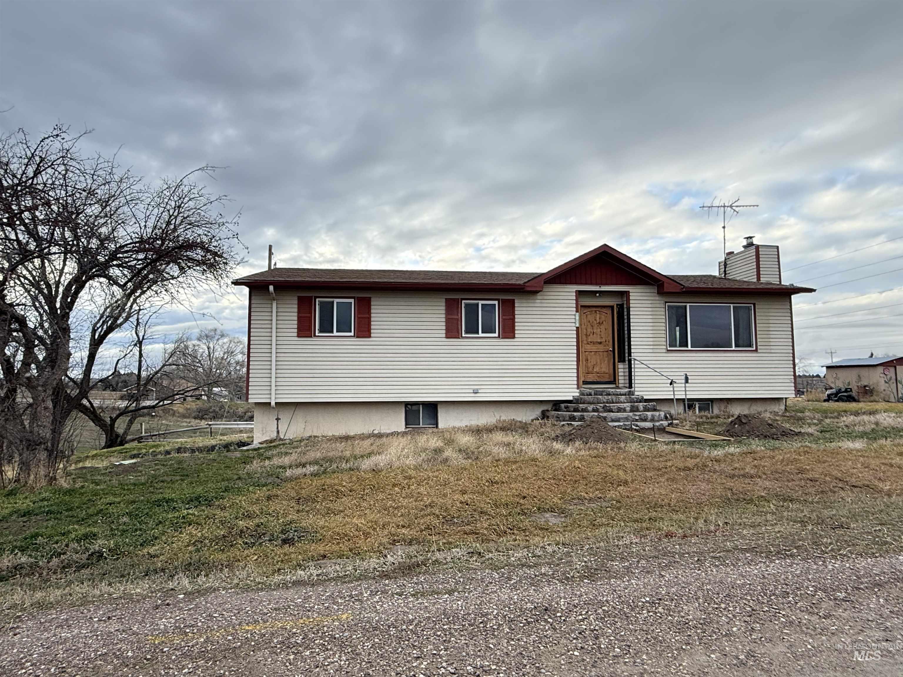 View of front of house featuring entry steps and a chimney