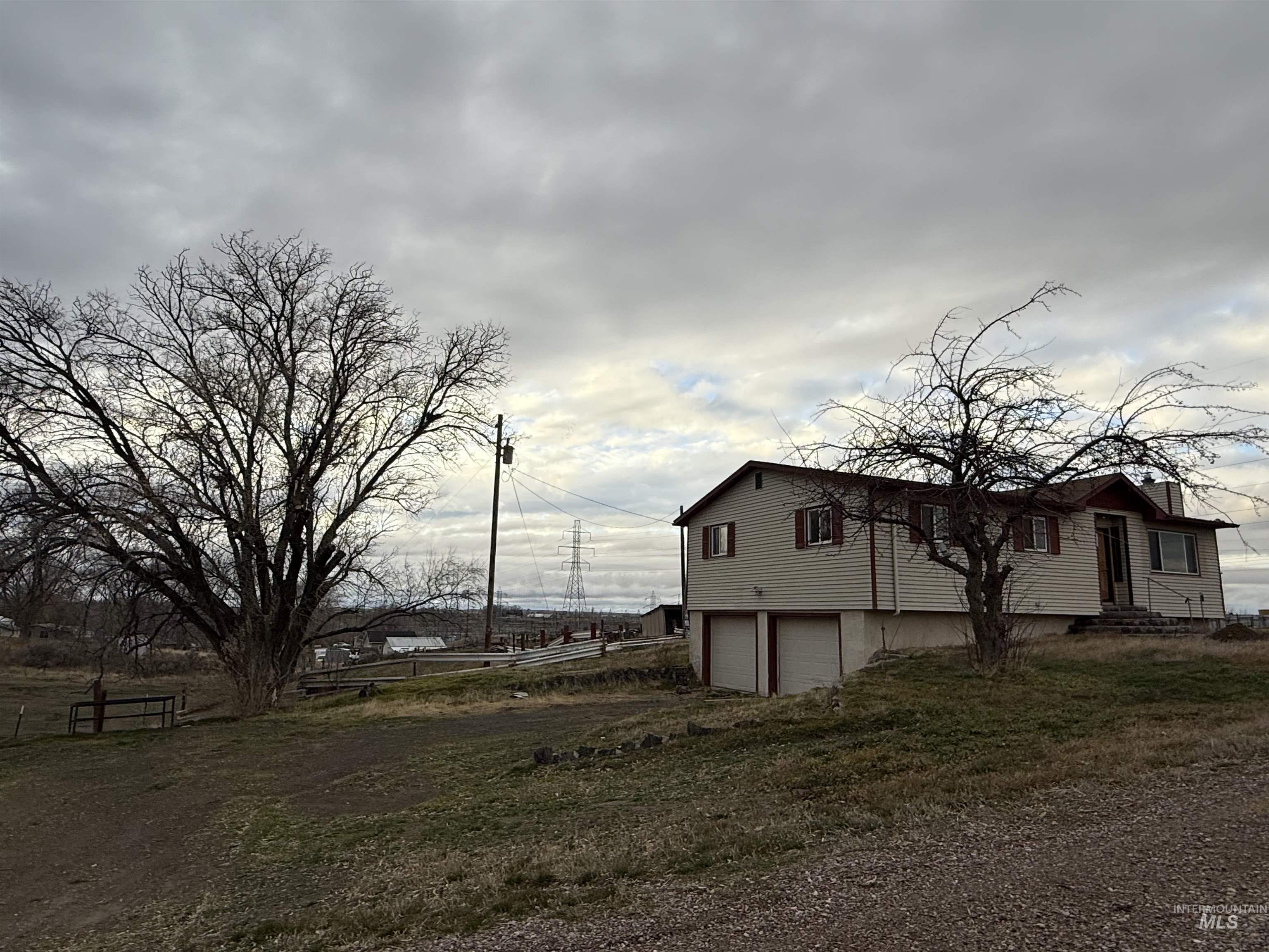 View of side of property featuring a garage and driveway
