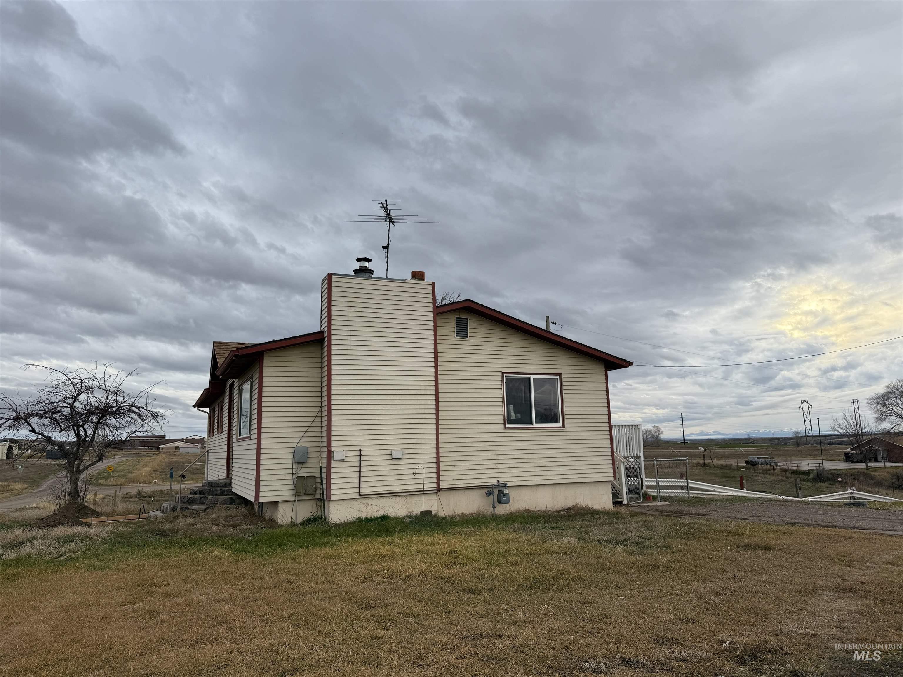 View of side of home with a chimney
