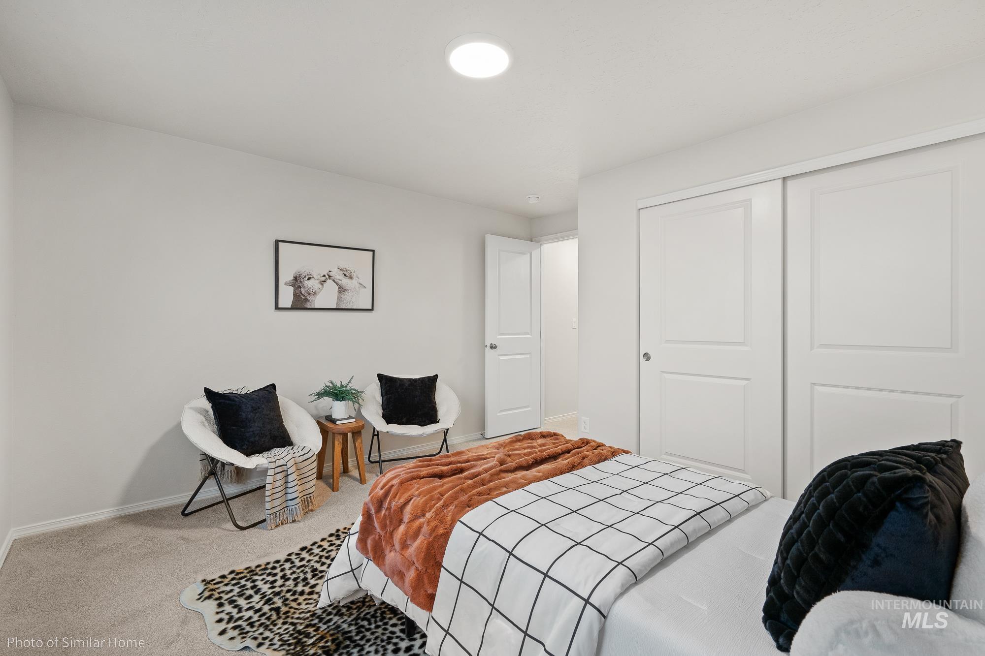 Carpeted bedroom featuring a closet and baseboards