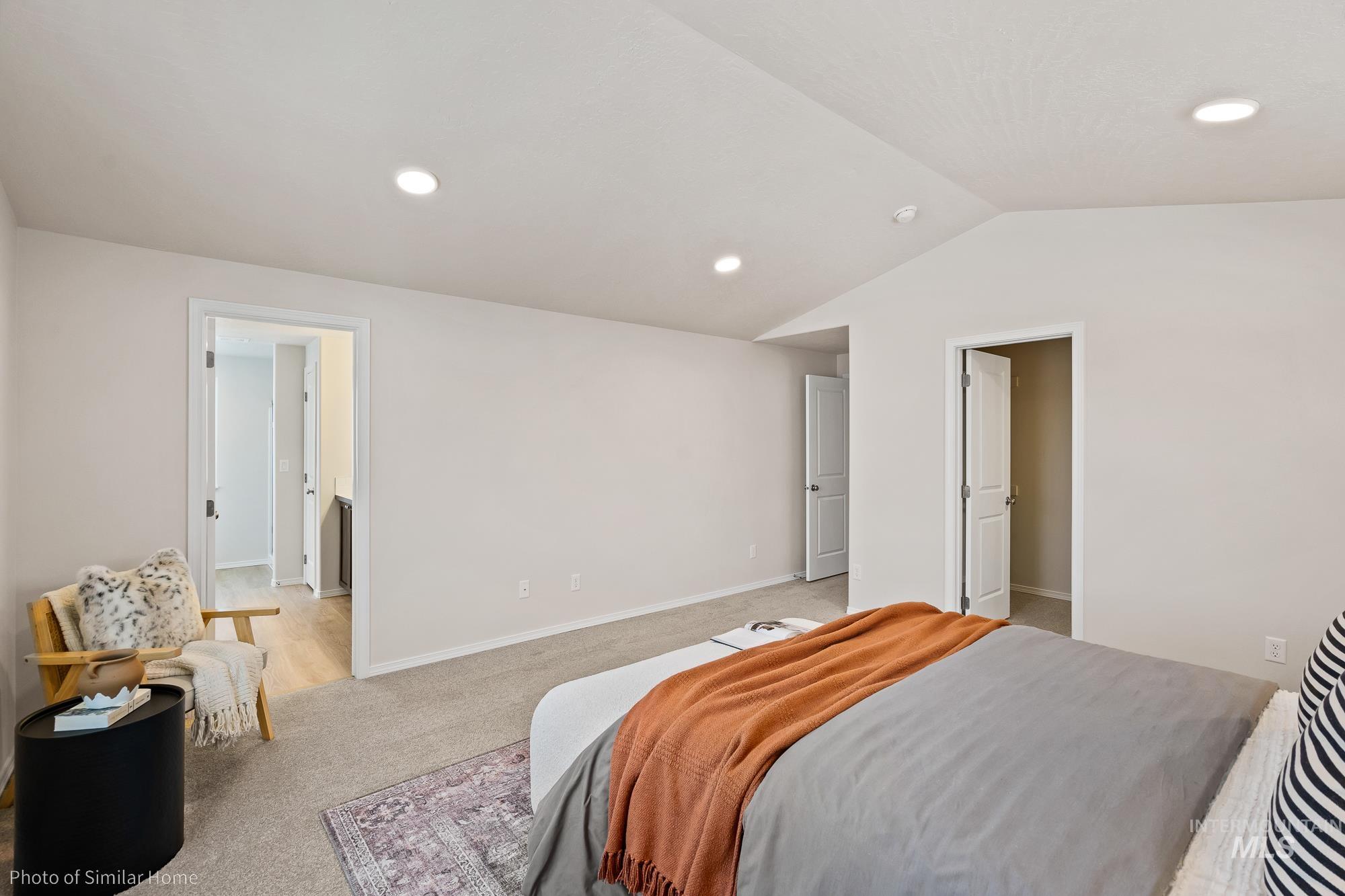 Bedroom featuring light carpet, recessed lighting, and vaulted ceiling