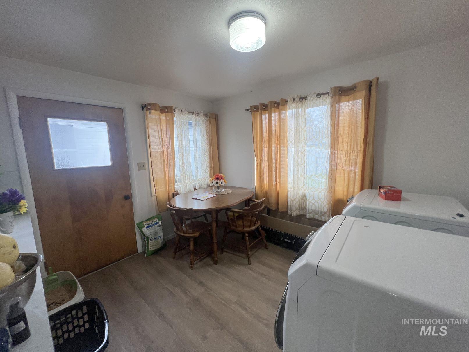 Dining room featuring wood finished floors and washing machine and dryer