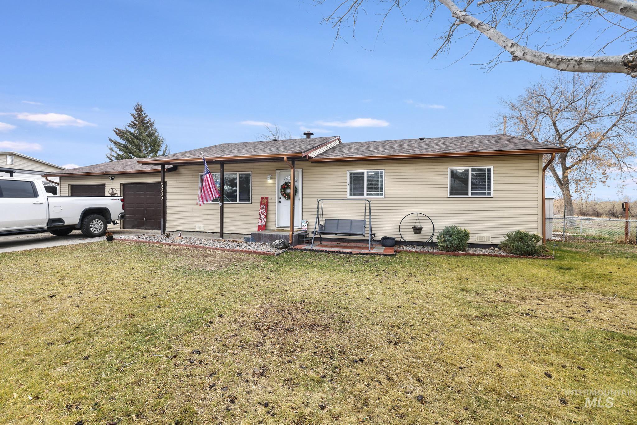 Single story home featuring roof with shingles, a garage, and driveway