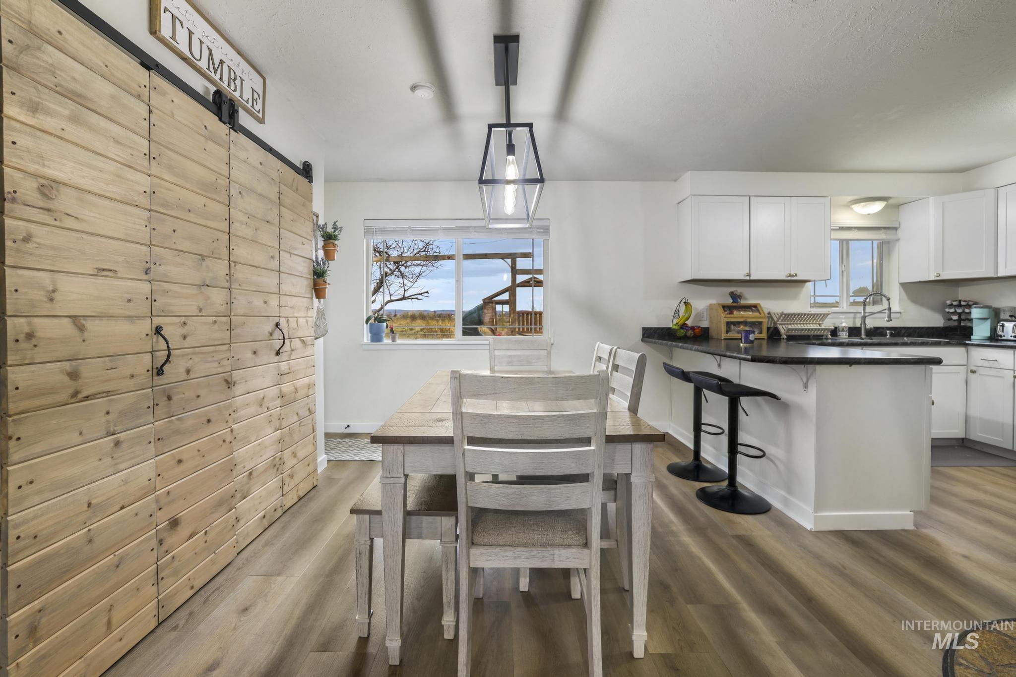 Dining area featuring healthy amount of natural light and dark wood-type flooring