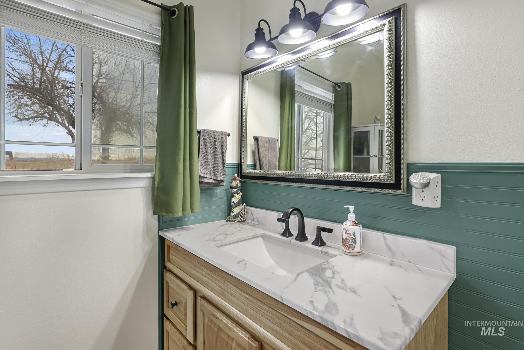 Bathroom with vanity and wainscoting