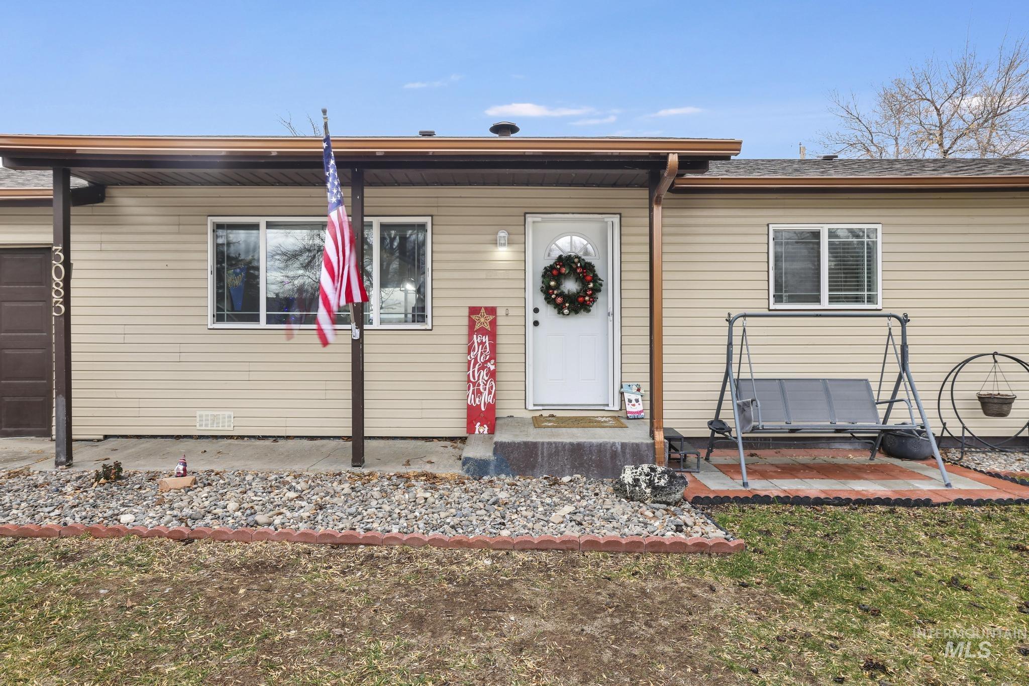 View of front facade featuring an attached garage and a front yard