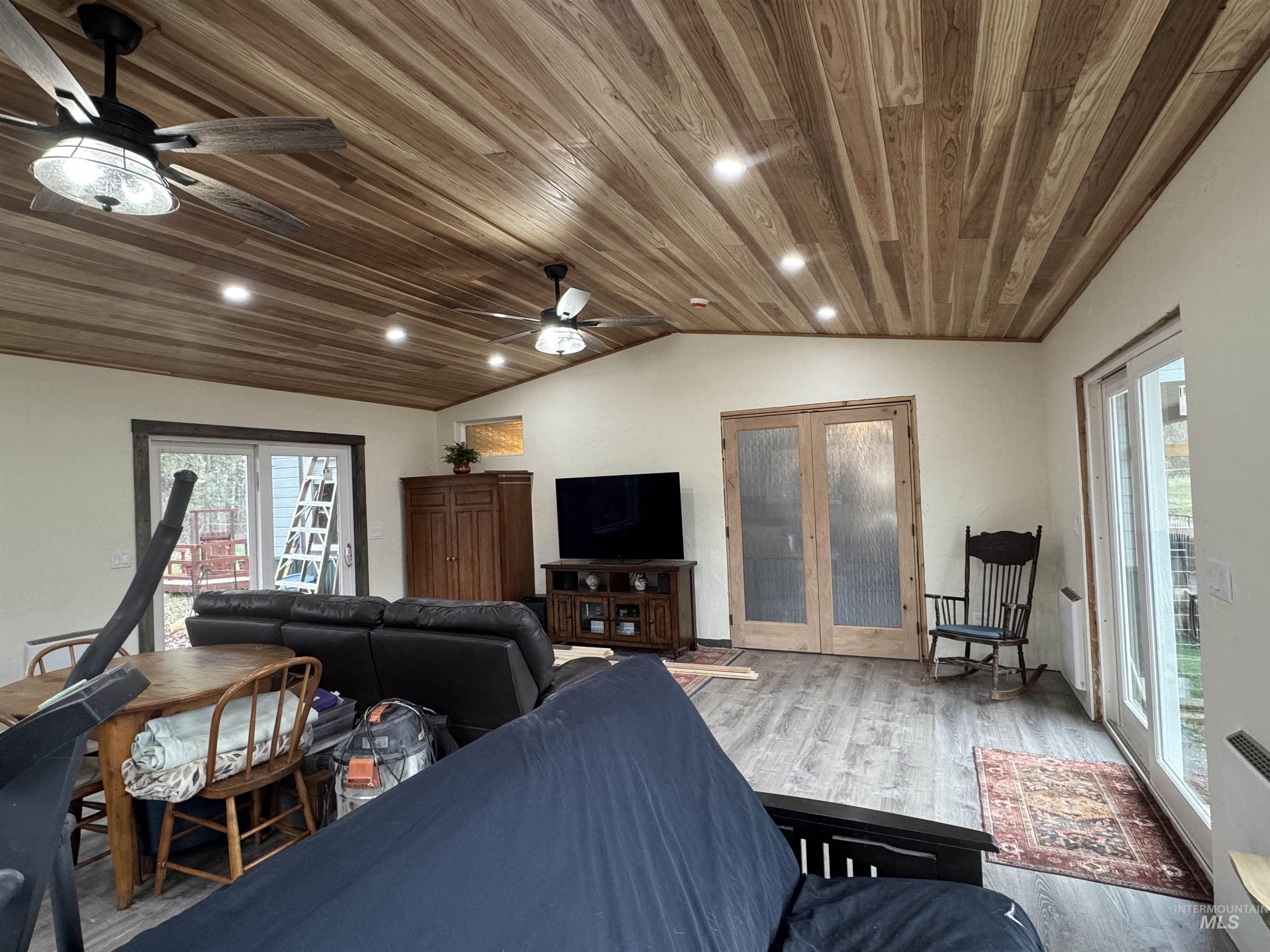 Family room off the main house, featuring wood finished floors, vaulted ceiling, wood ceiling, recessed lighting, and ceiling fan