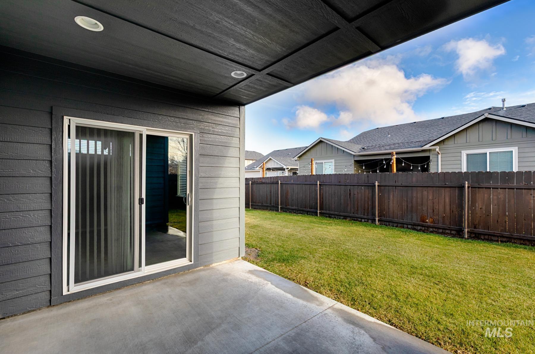 Fenced backyard with a patio area