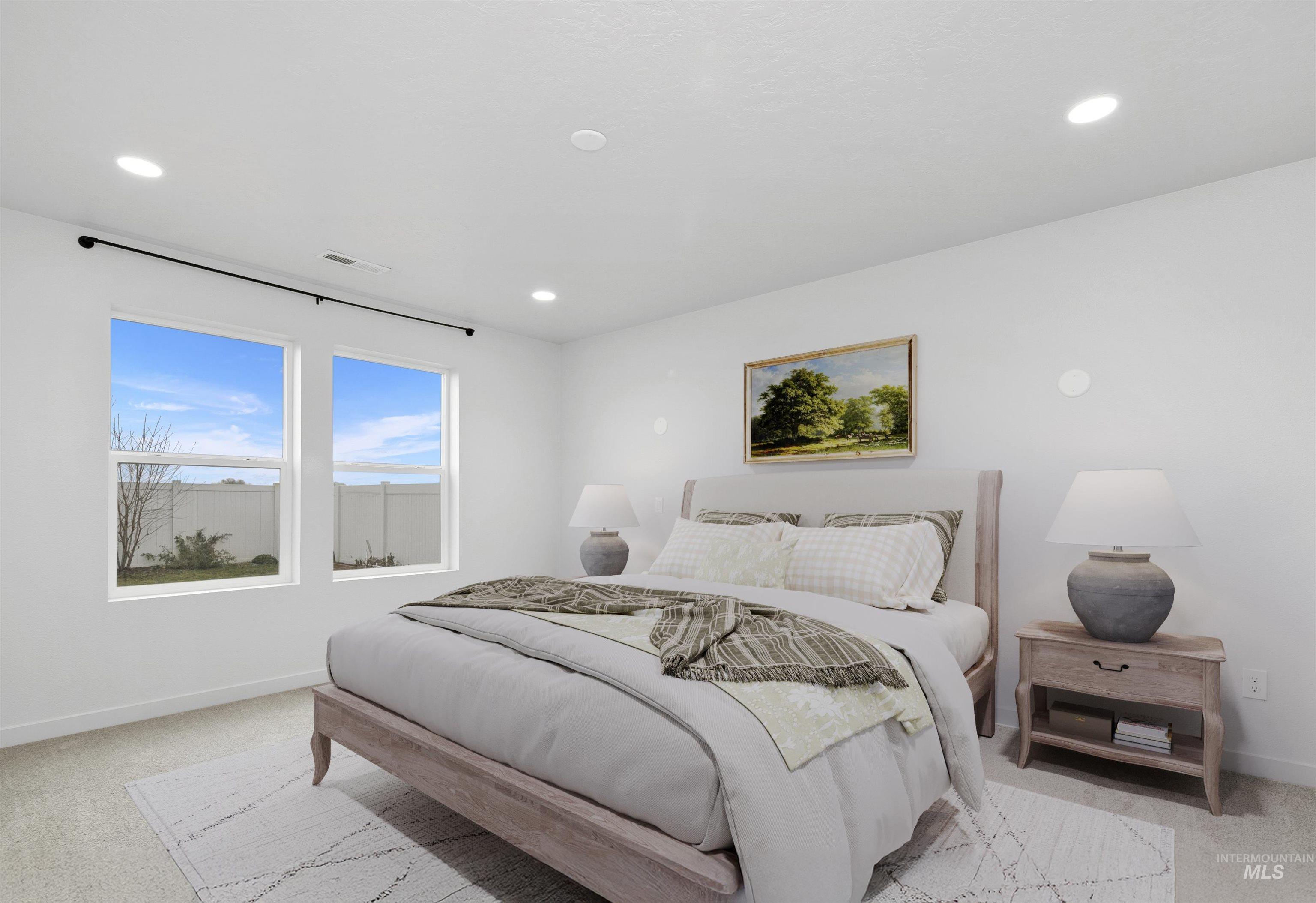 Bedroom with light carpet and recessed lighting