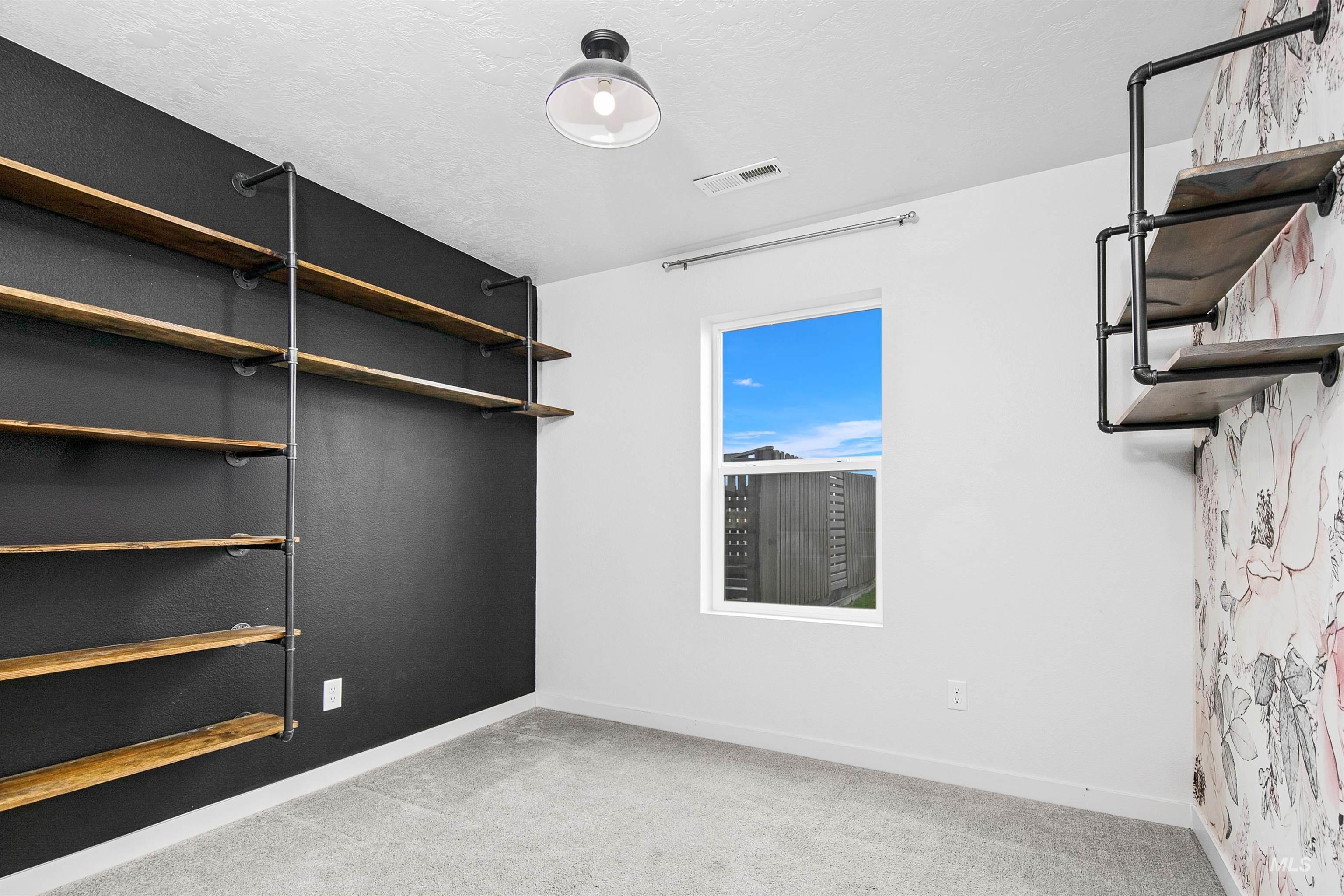 Spacious closet with light colored carpet