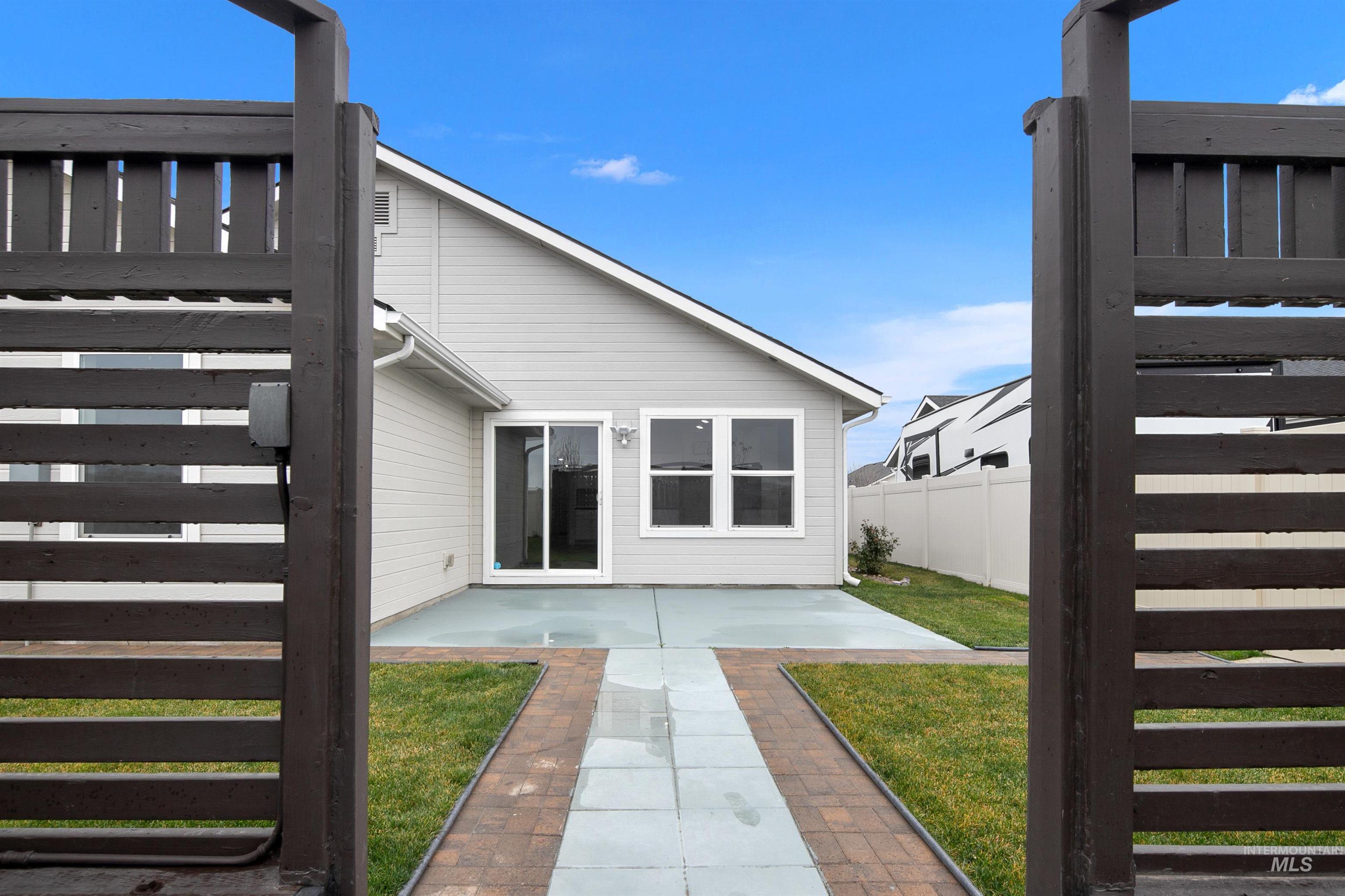 Rear view of house featuring stairway and a patio area