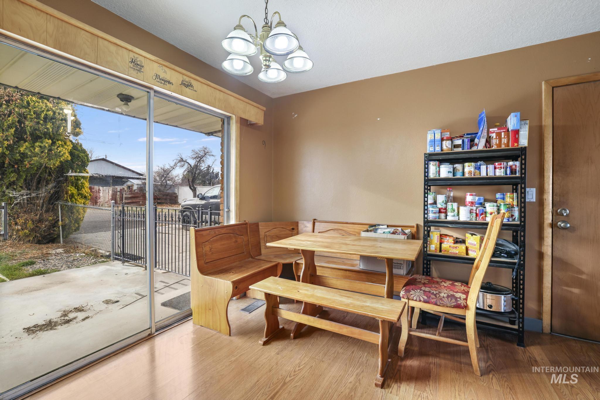 Dining space with a chandelier and wood finished floors