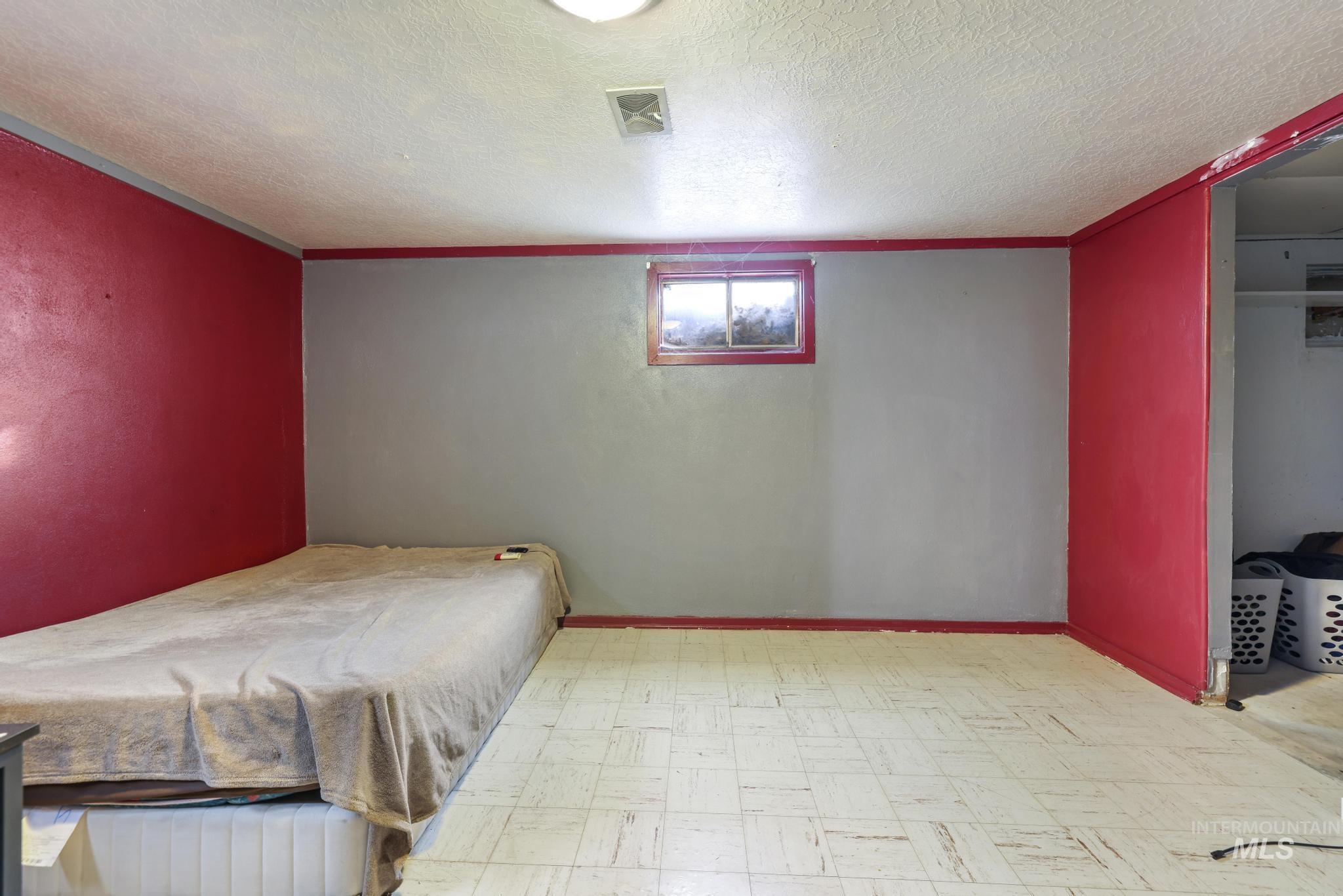 Bedroom featuring tile patterned floors and a textured ceiling