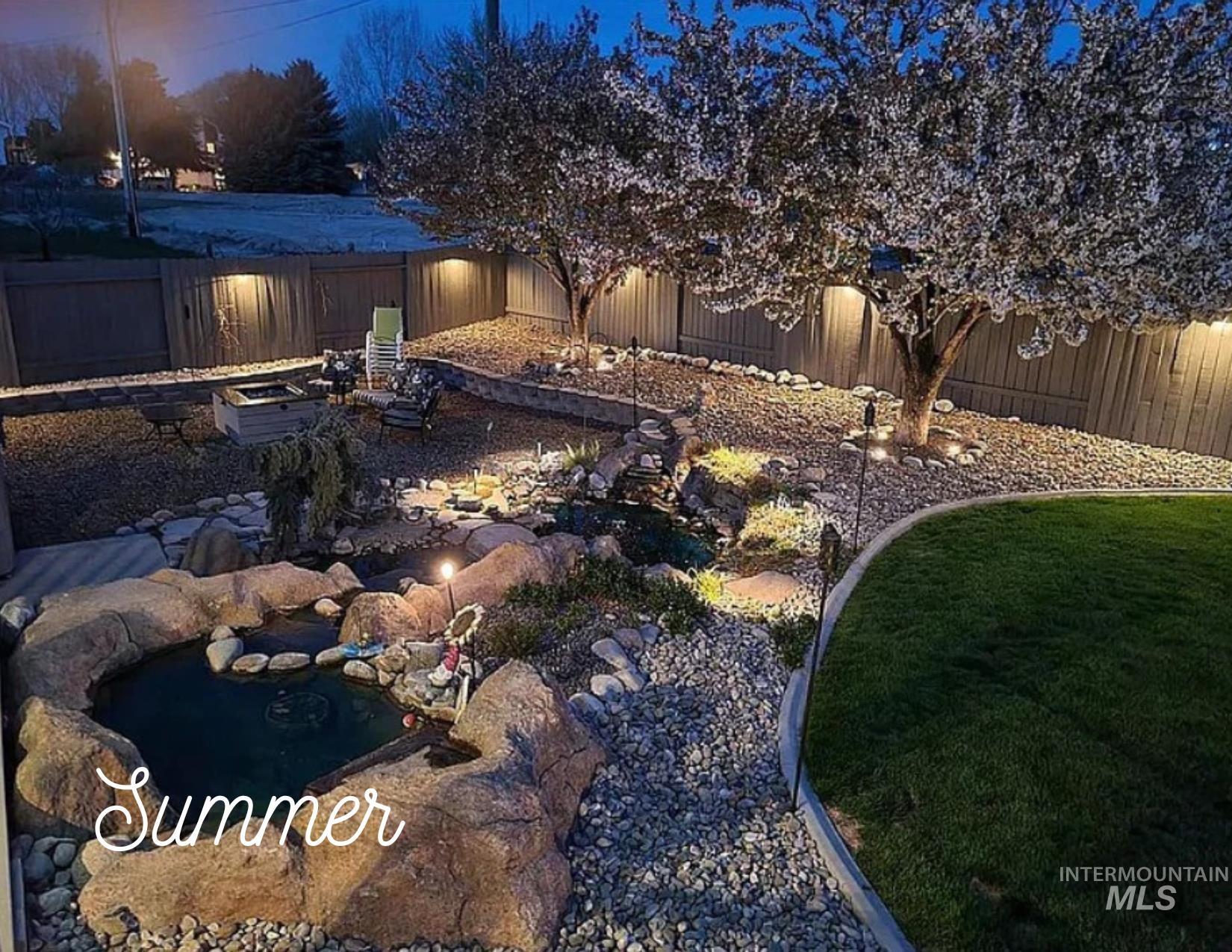 Fenced backyard with a garden pond