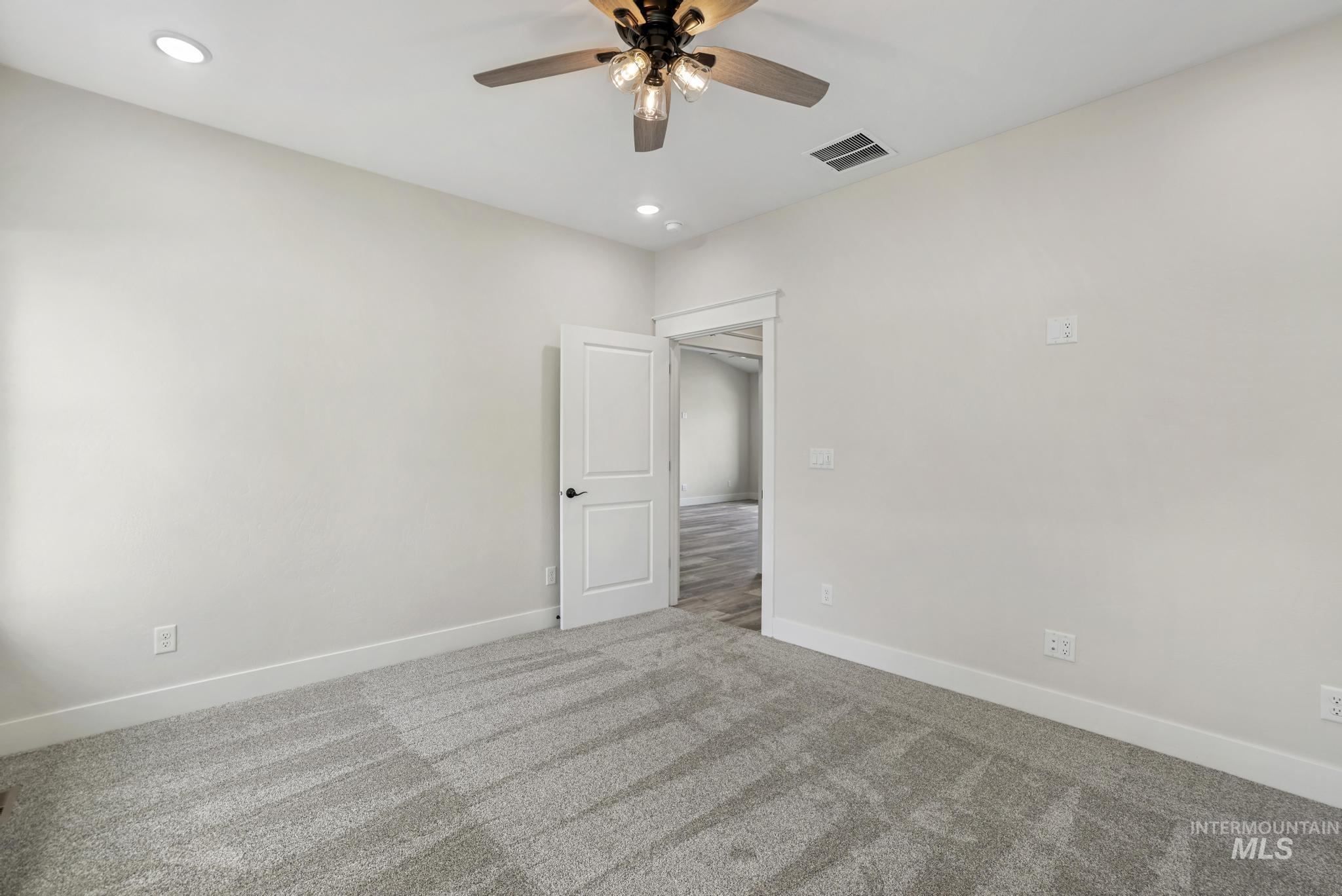 Unfurnished room with carpet flooring, recessed lighting, and a ceiling fan