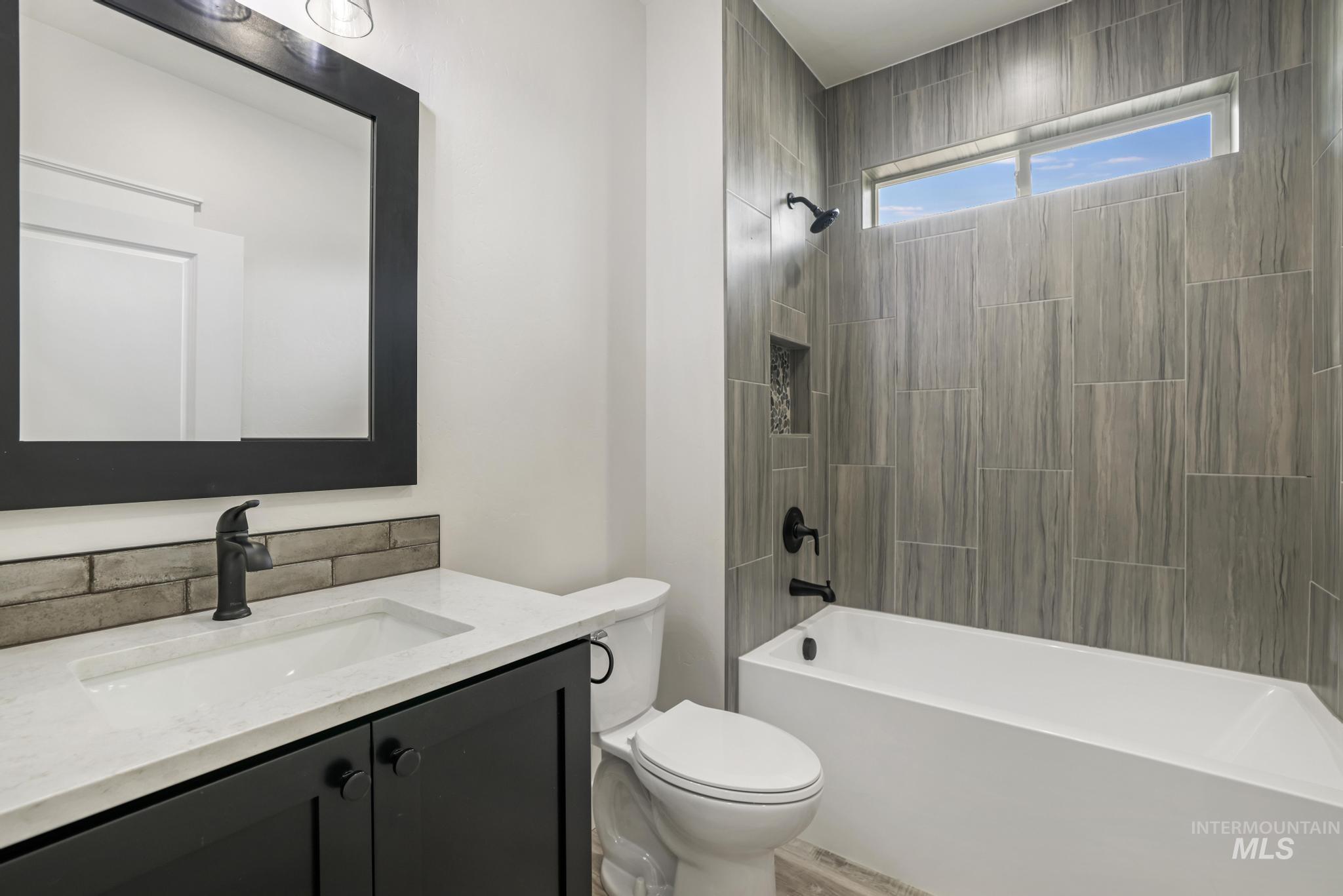 Bathroom with shower / bathtub combination and vanity
