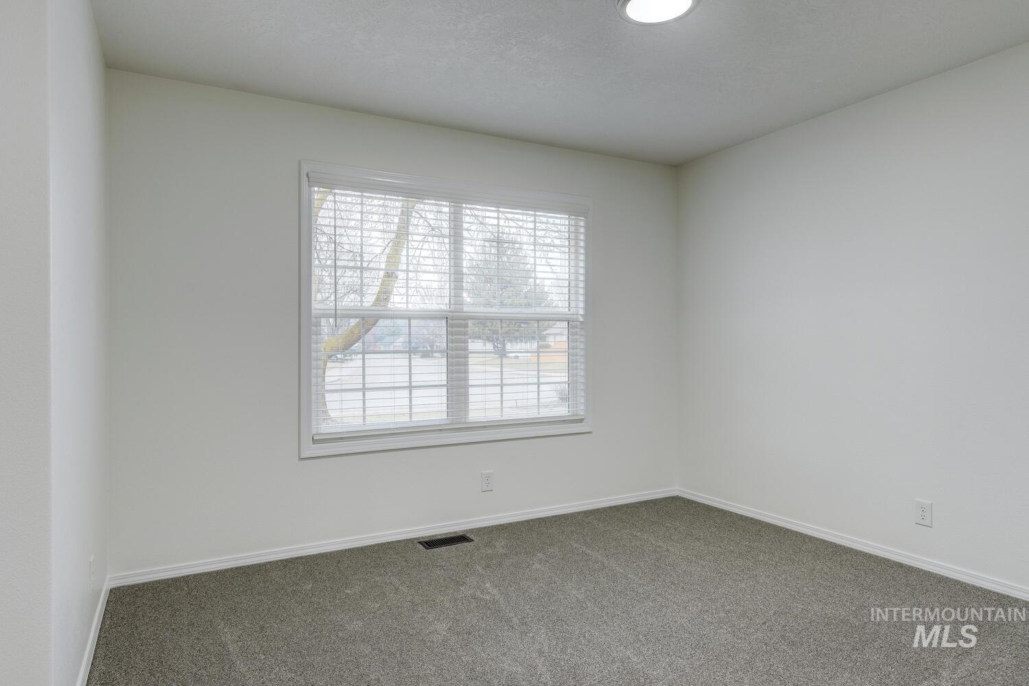 Spare room with baseboards and carpet floors